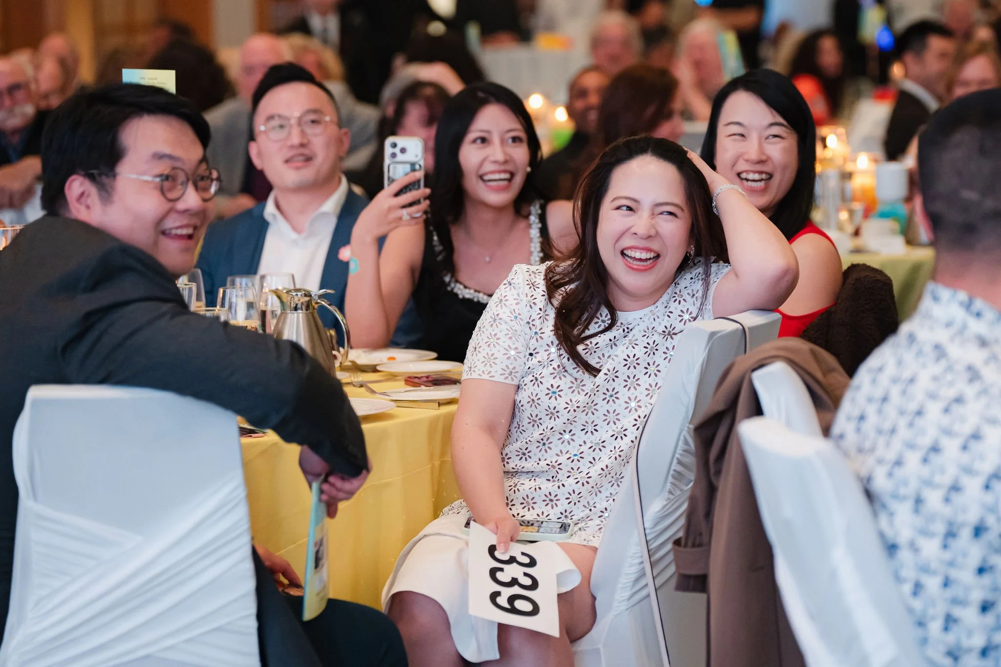 Guests laughing together at a Vancouver fundraising gala