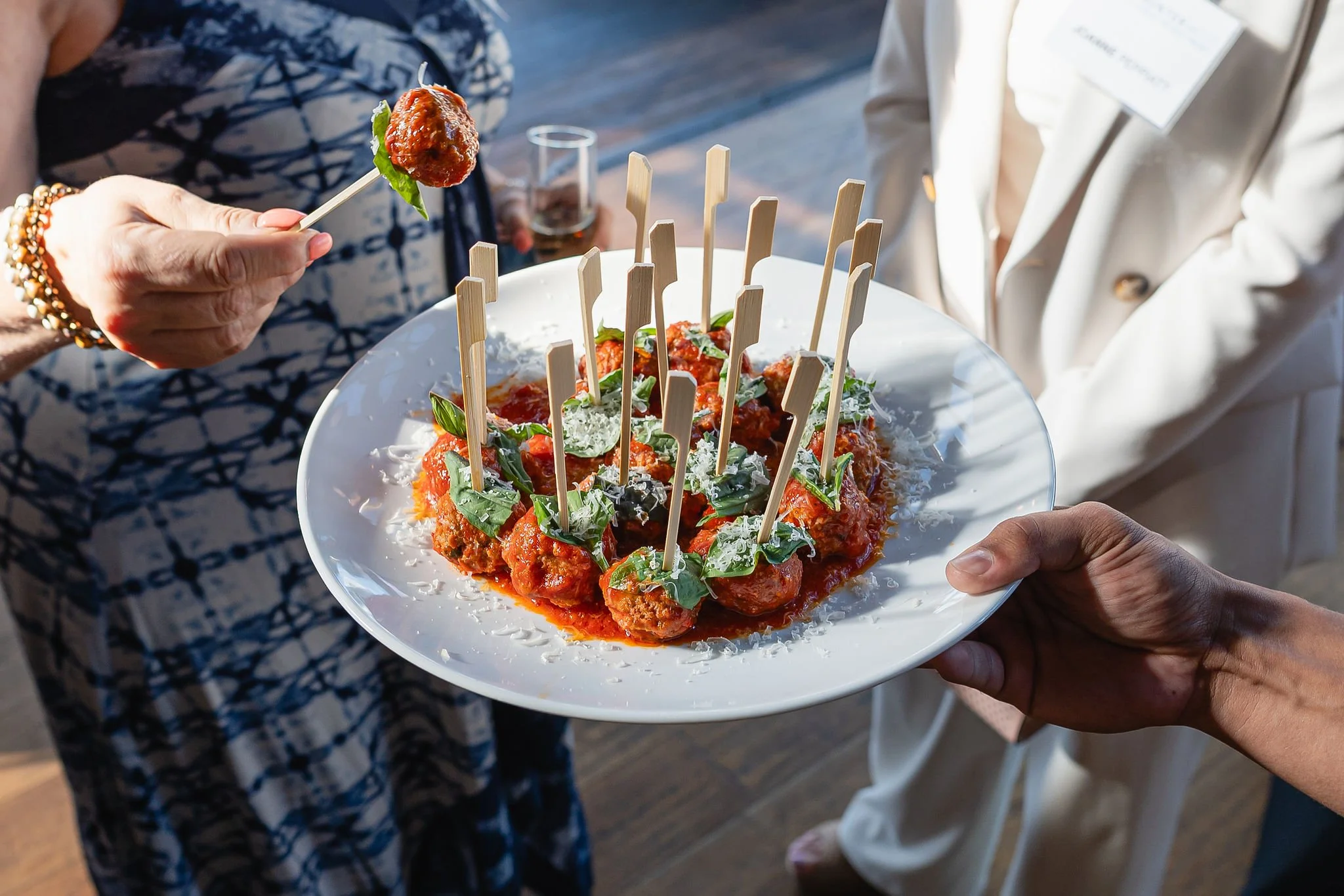 Server presenting passed hors d'oeuvres to event guests