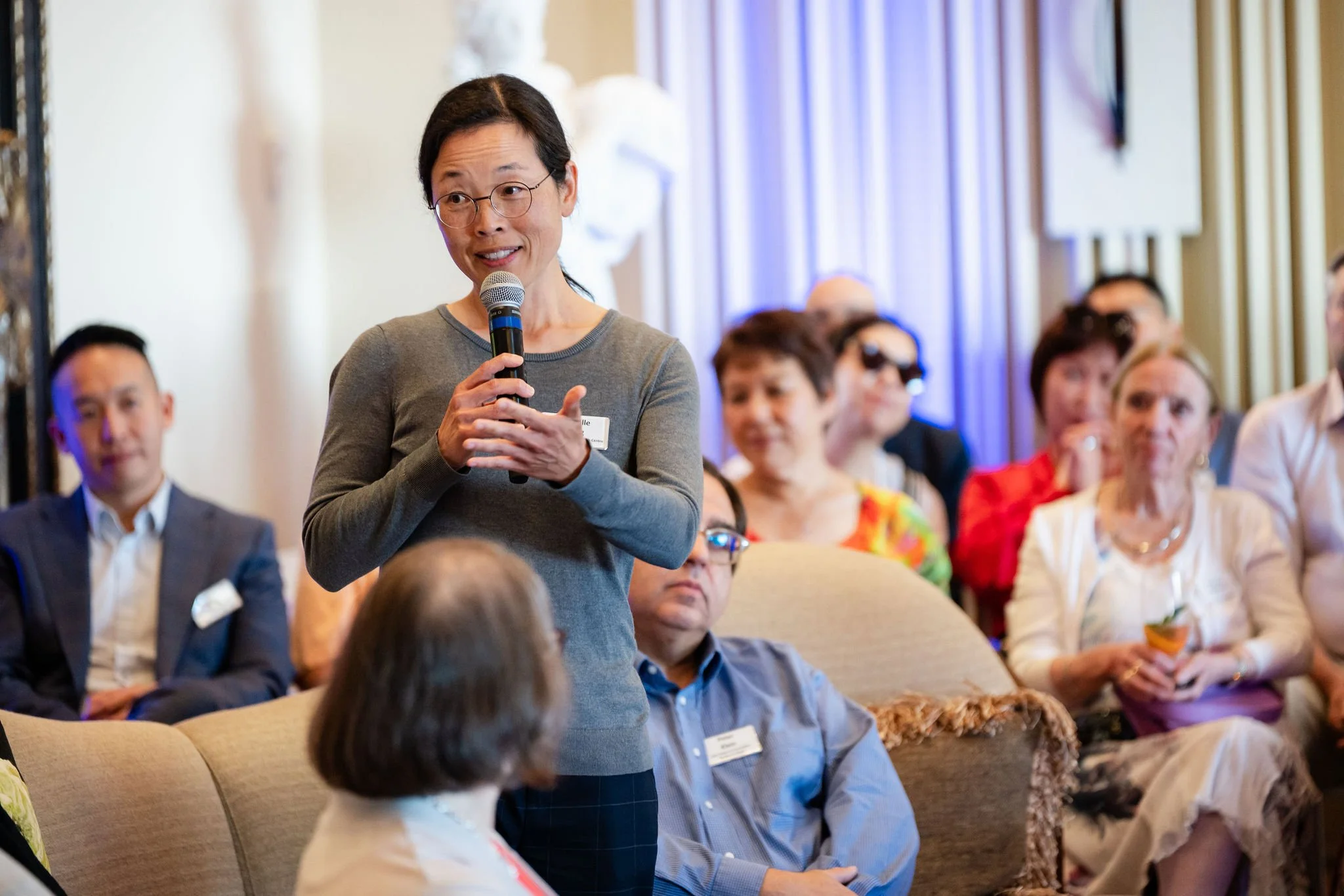 Woman leading an intimate discussion with seated guests