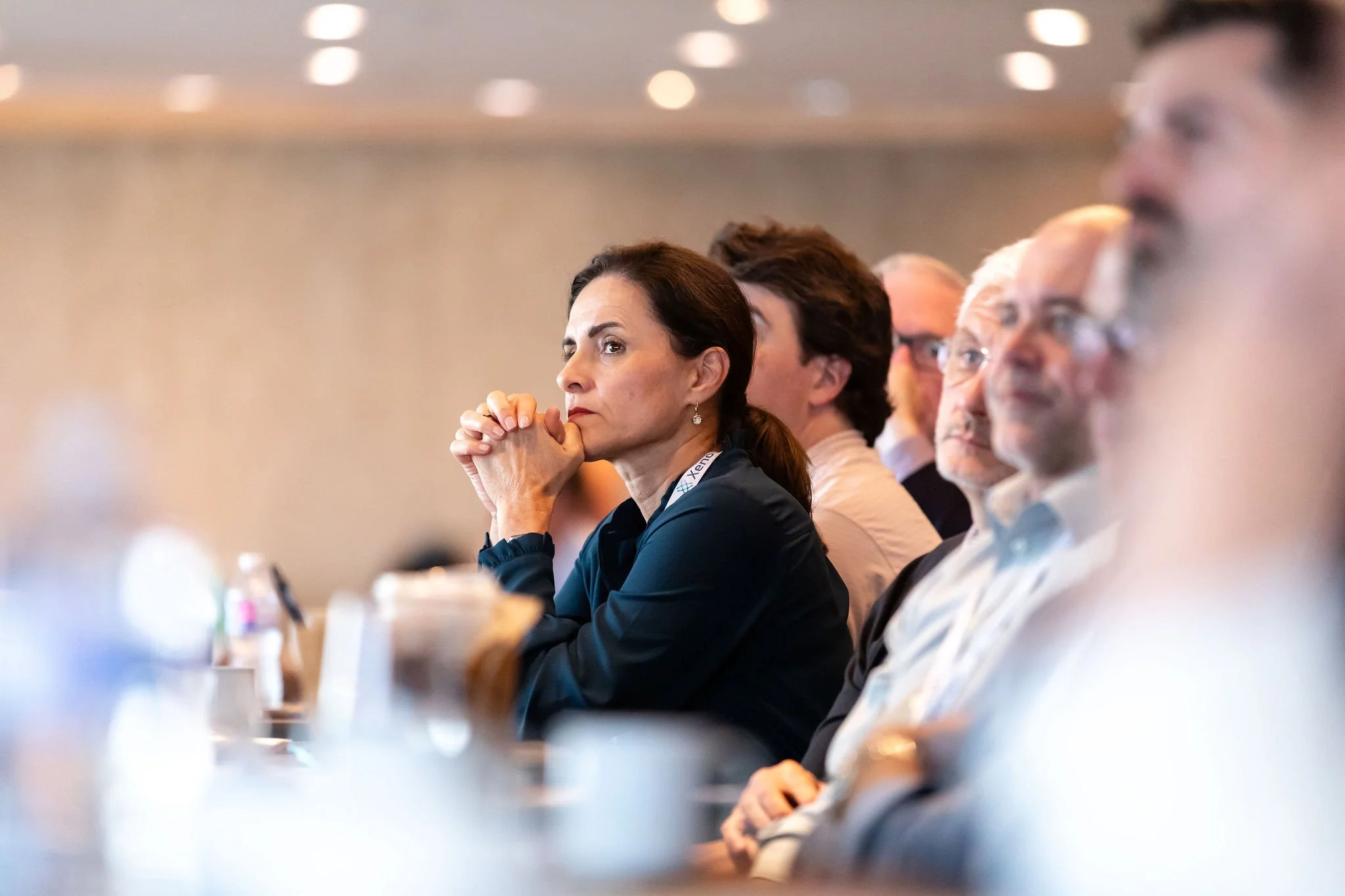 Conference attendee listening attentively during a panel discussion