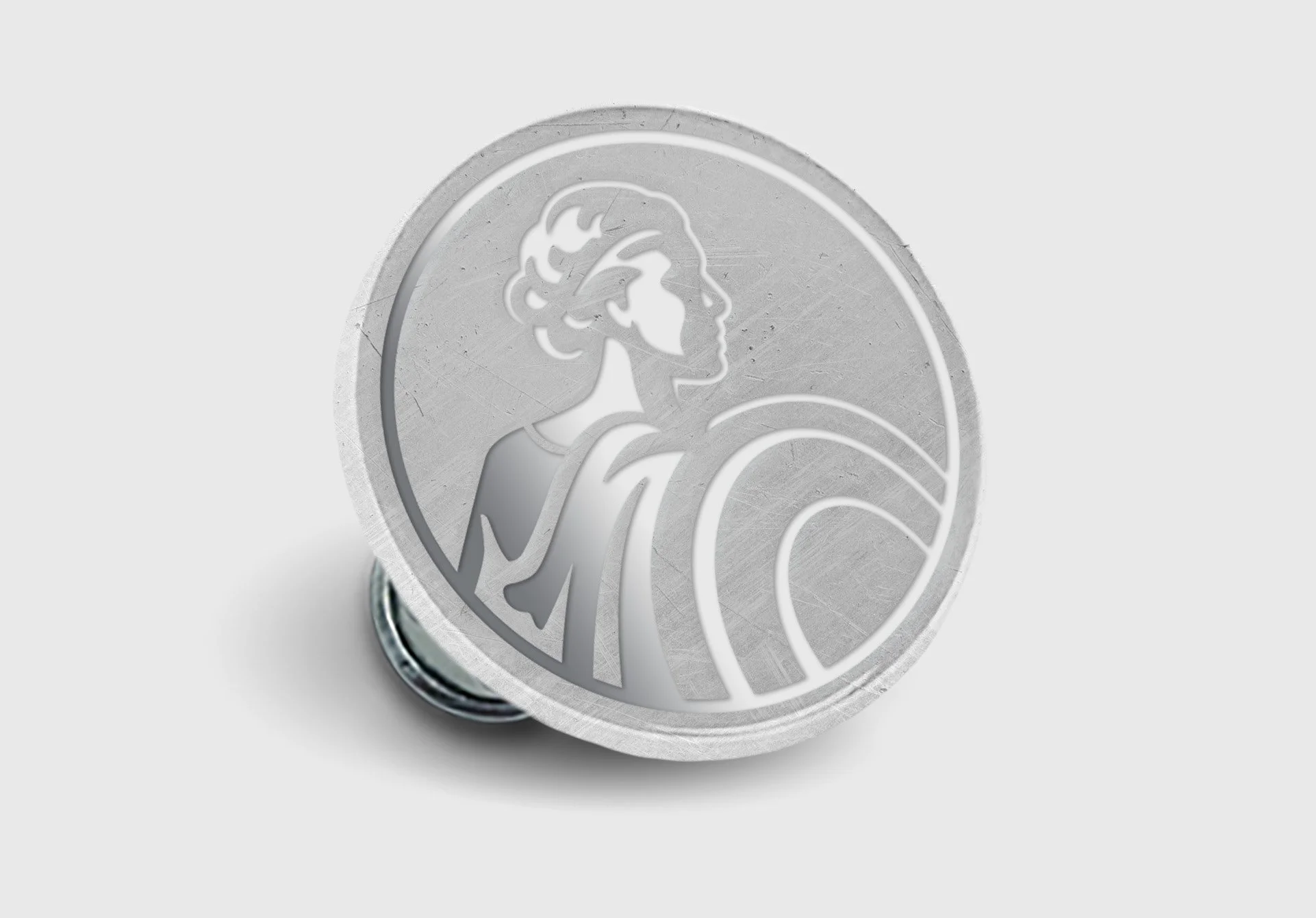 A round metallic button featuring an embossed woman with wavy hair, wearing a dress, holding a basketball.