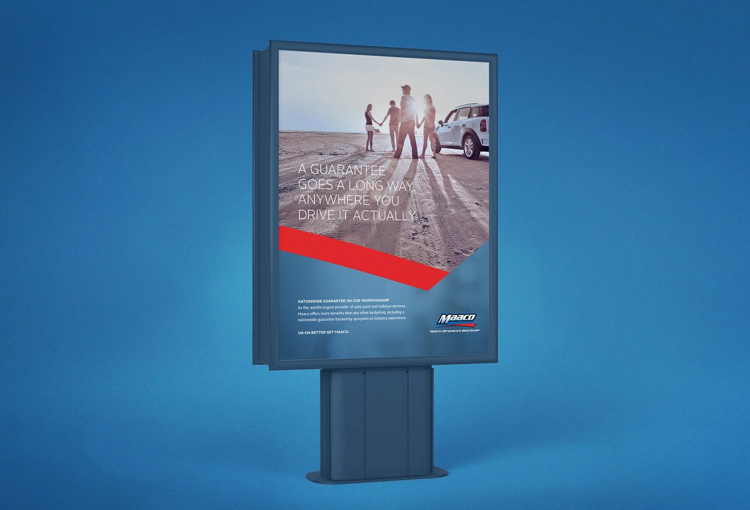 An outdoor billboard shows a photo of four people holding hands on a dirt road with a white vehicle nearby. The text says, 'A guarantee goes a long way anywhere you drive it actually.'