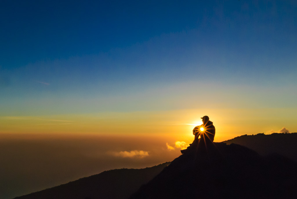 A climber watches sunset on Kilimanjaro, Tanzania