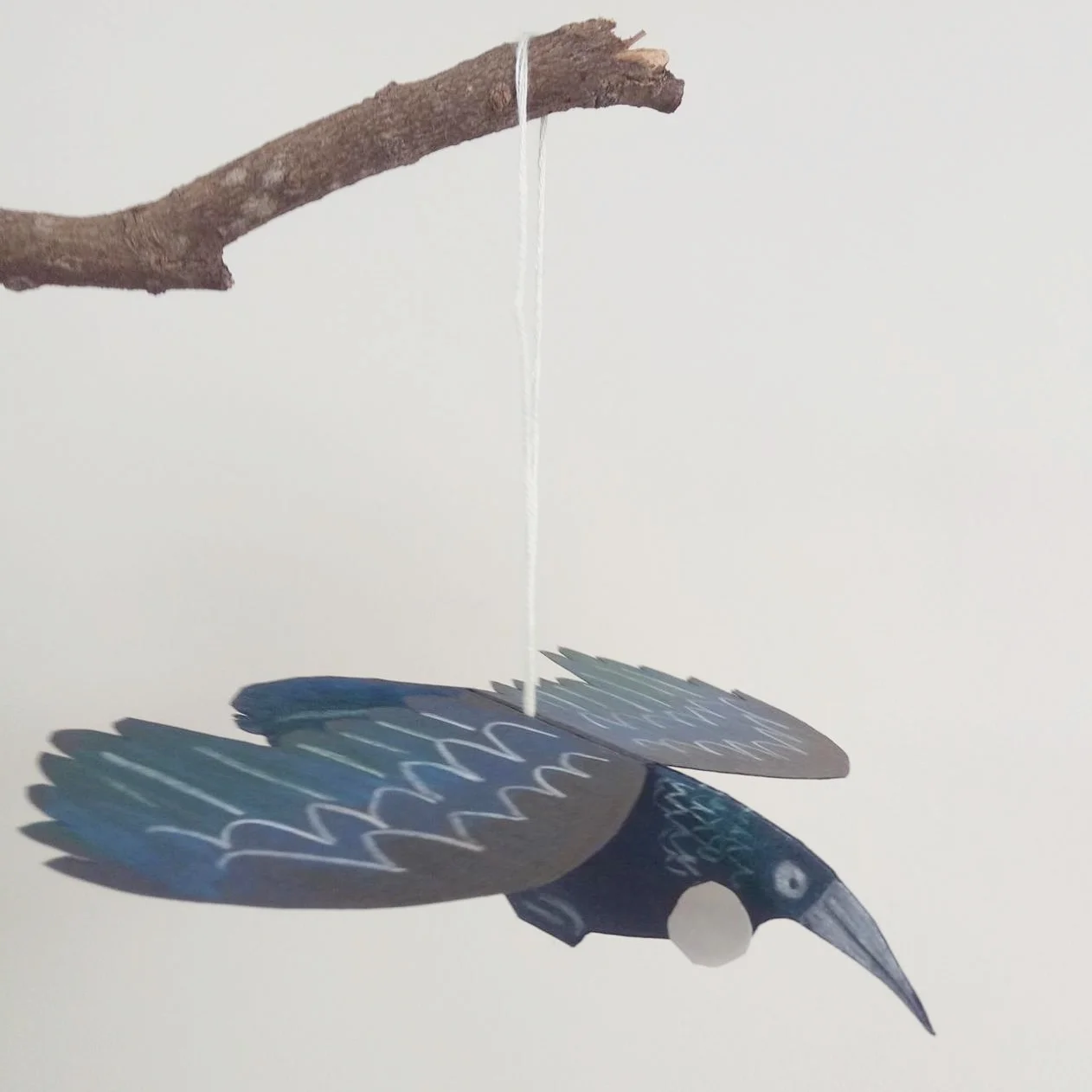 Paper cut tui - coloured pencil on paper. Paper ornament workshop example .