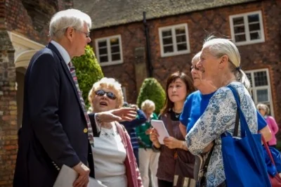 An experienced Tour Guide, Alan Malcom, with a tour group at Fulham Palace”