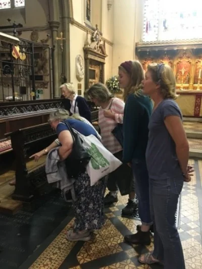 A tour group exploring a chapel on a Volunteers' day trip!