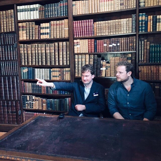Showing my first visitor (who happened to be my brother) around the library.
