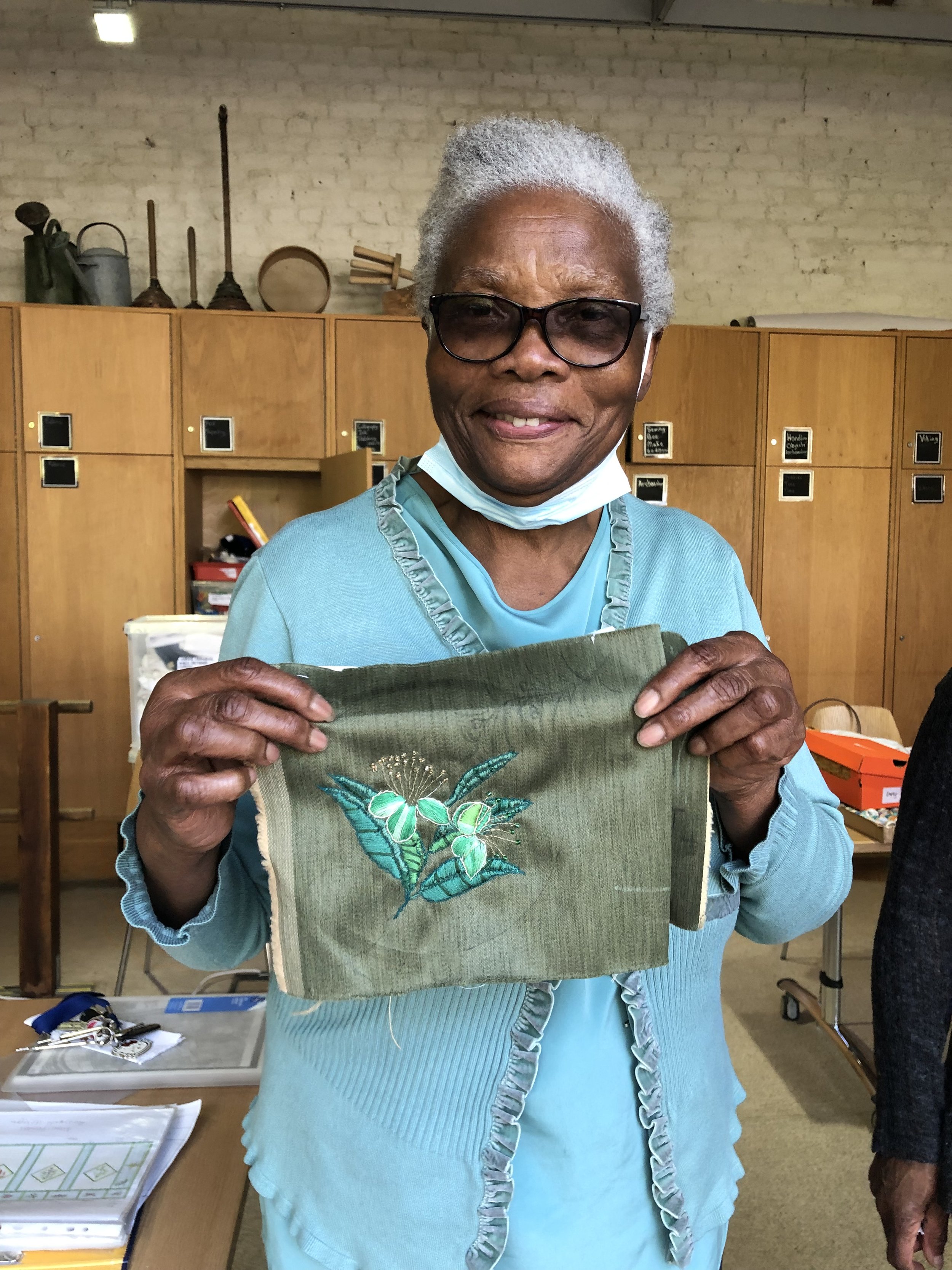 myrtle holding embroidery.jpg