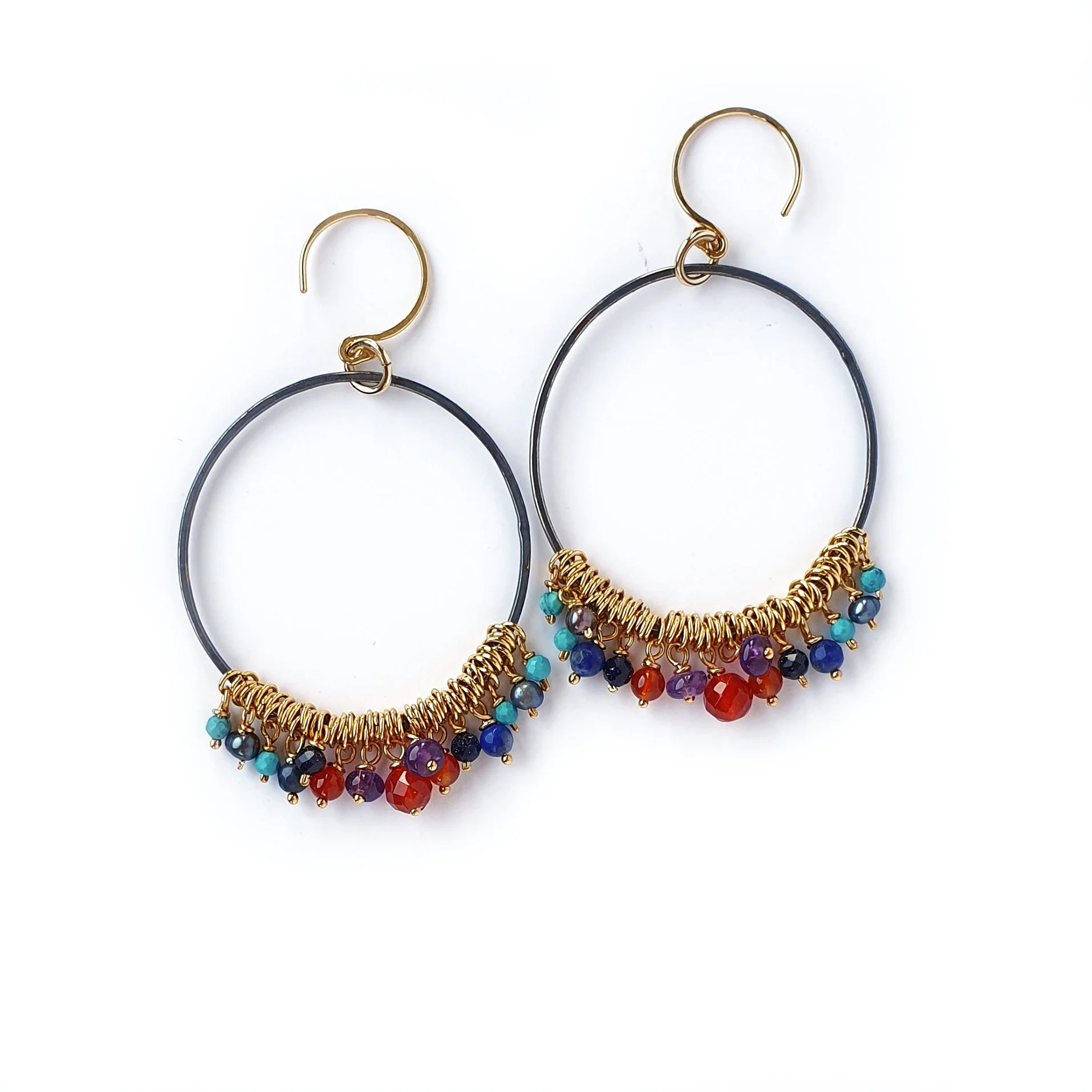 Large hoop earrings. Handmade with oxidised silver hoops and gold vermeil ear hooks. Hanging from the hoops are small beads of Amethyst, Lapis Lazuli, Carnelian, grey Pearl, blue Goldstone, Turquoise.