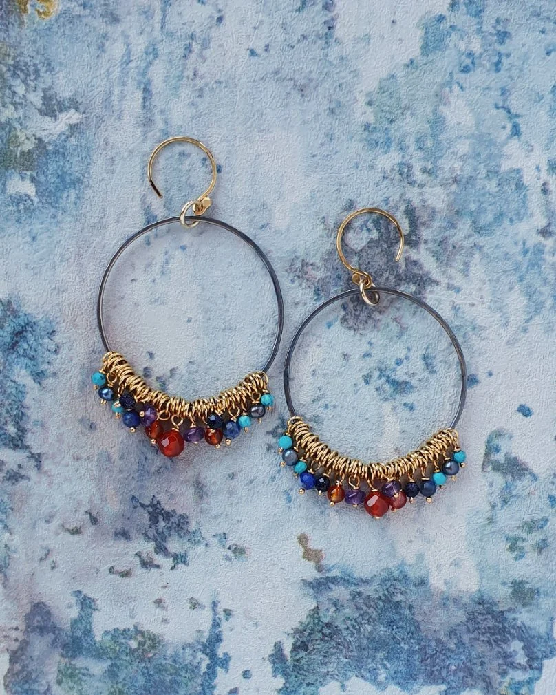 Large hoop earrings. Handmade with oxidised silver hoops and gold vermeil ear hooks. Hanging from the hoops are small beads of Amethyst, Lapis Lazuli, Carnelian, grey Pearl, blue Goldstone, Turquoise.
