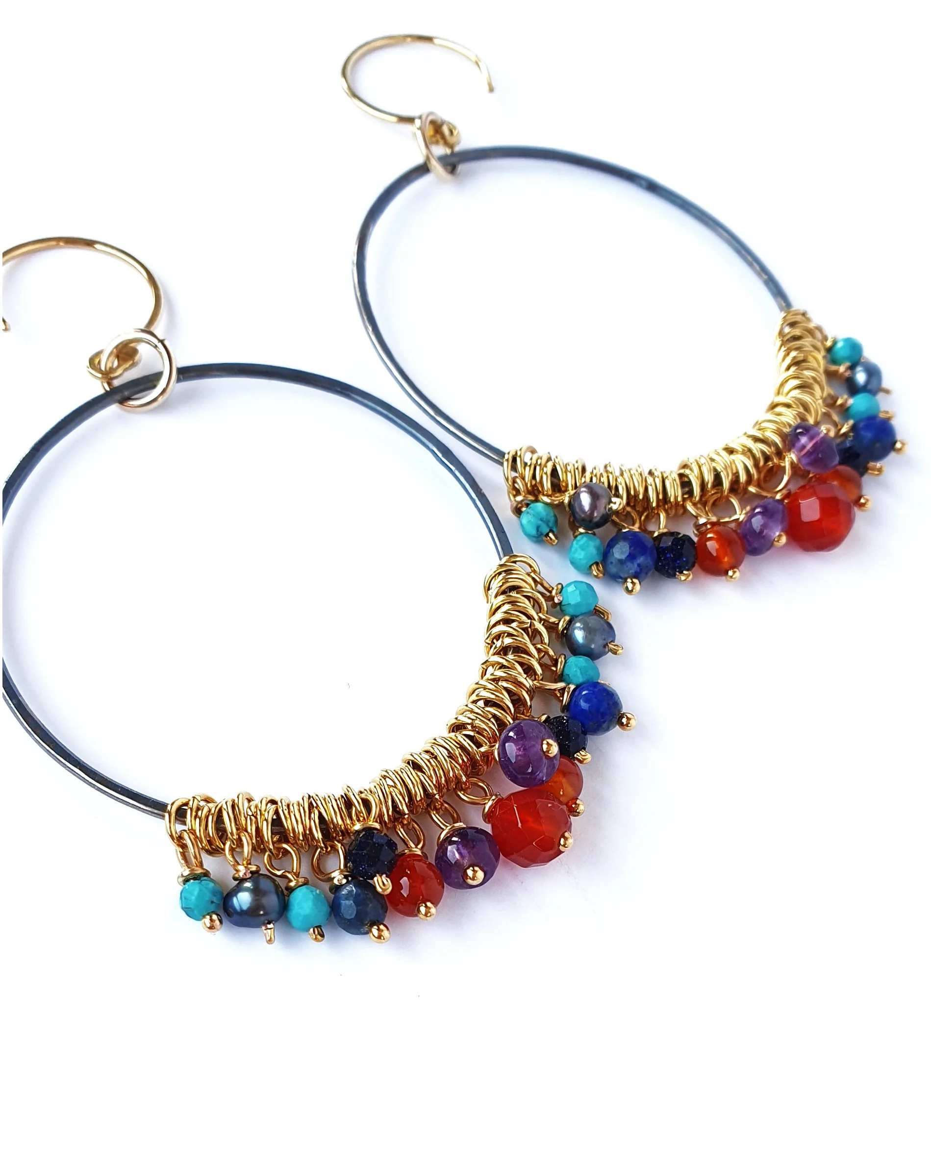 Large hoop earrings. Handmade with oxidised silver hoops and gold vermeil ear hooks. Hanging from the hoops are small beads of Amethyst, Lapis Lazuli, Carnelian, grey Pearl, blue Goldstone, Turquoise.