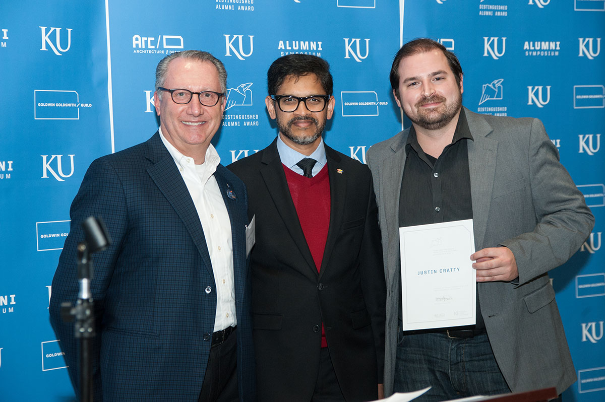 Justin Cratty, right, receives his award from Dean Daas, center