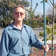 Dave posing with an Our City Forest ready-stake and tree.