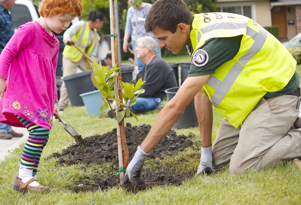 Americorps and Child Planting.jpg