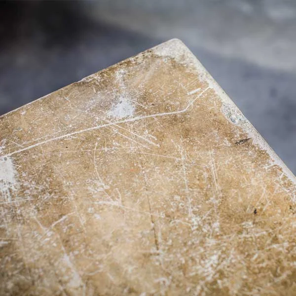 Repurposed concrete floor slab as coffee table top.