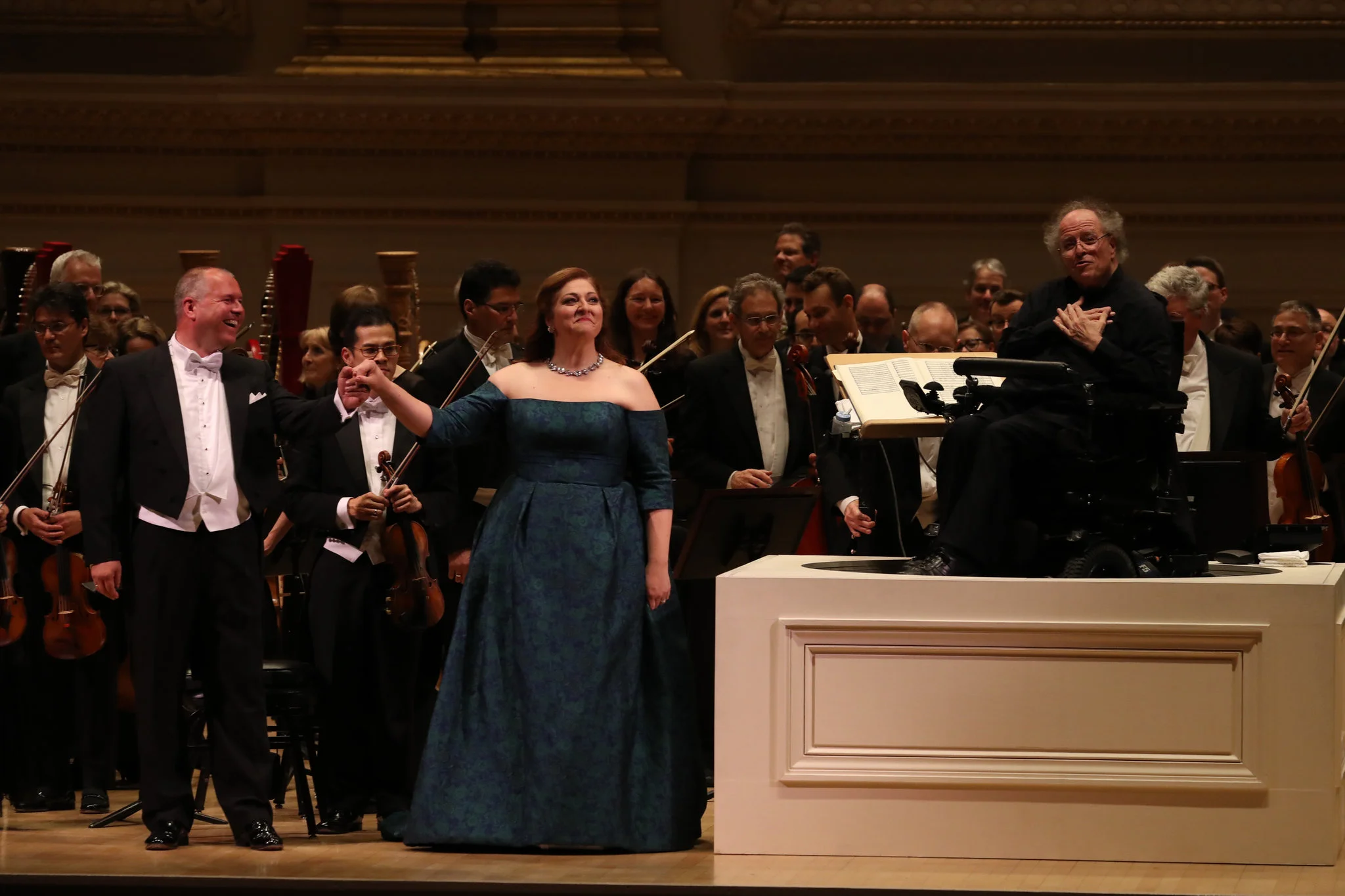 Stefan Vinke, far left; Christine Goerke, center; and, far right, the conductor James Levine, with the Met Orchestra at Carnegie Hall (Photo: New York Times )