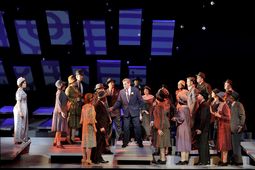 Golda Schultz as Clara (left) and William Burden as George Bailey with members of the San Francisco Opera Chorus