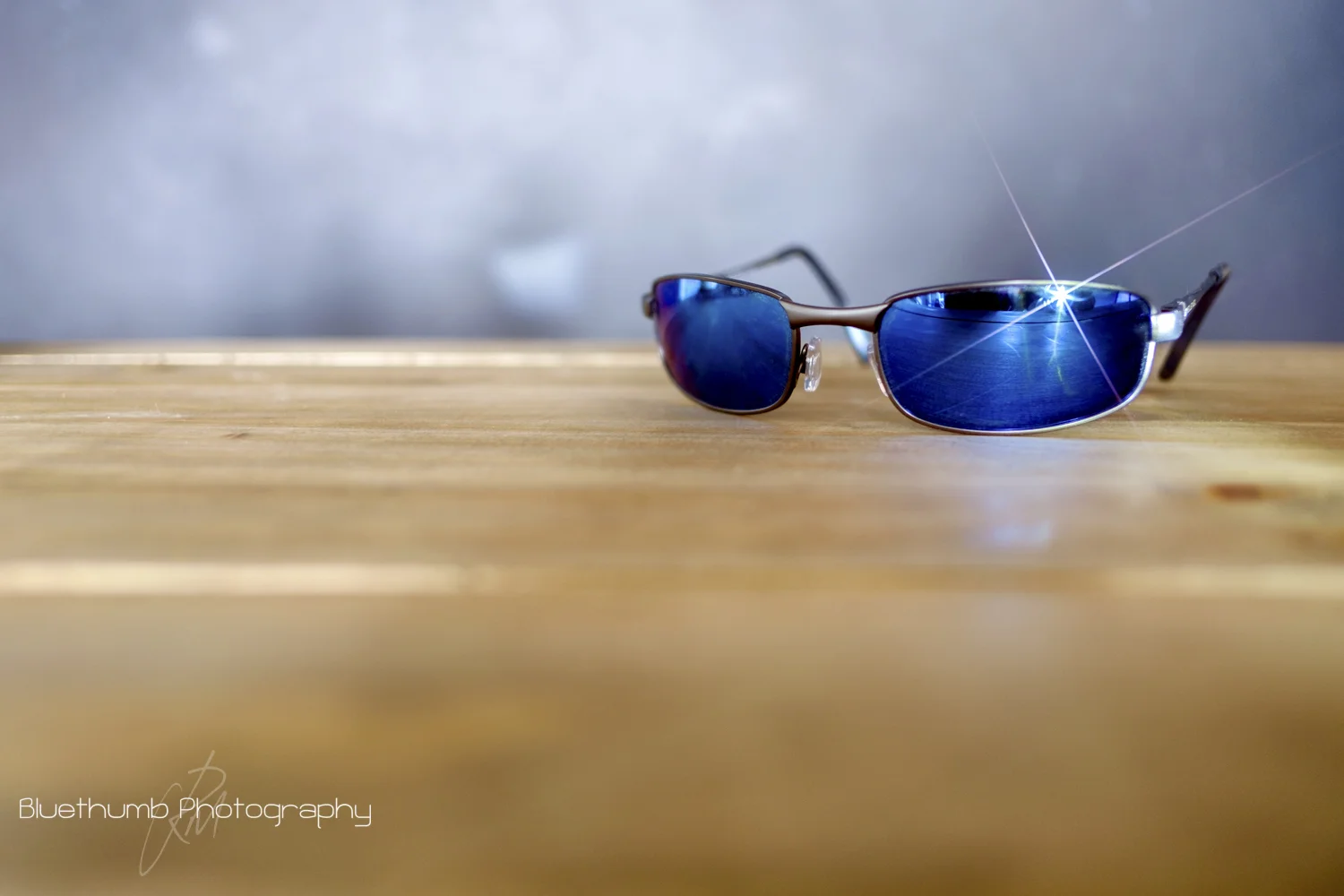 This was shot again on the XT1 and 18mm at f/2 ISO 200 1.3 sec. spot metered for the table top and camera on a tripod. The light source for this was a Led Lenser Cree LED torch shone at an angle directly onto the sunglasses lens.