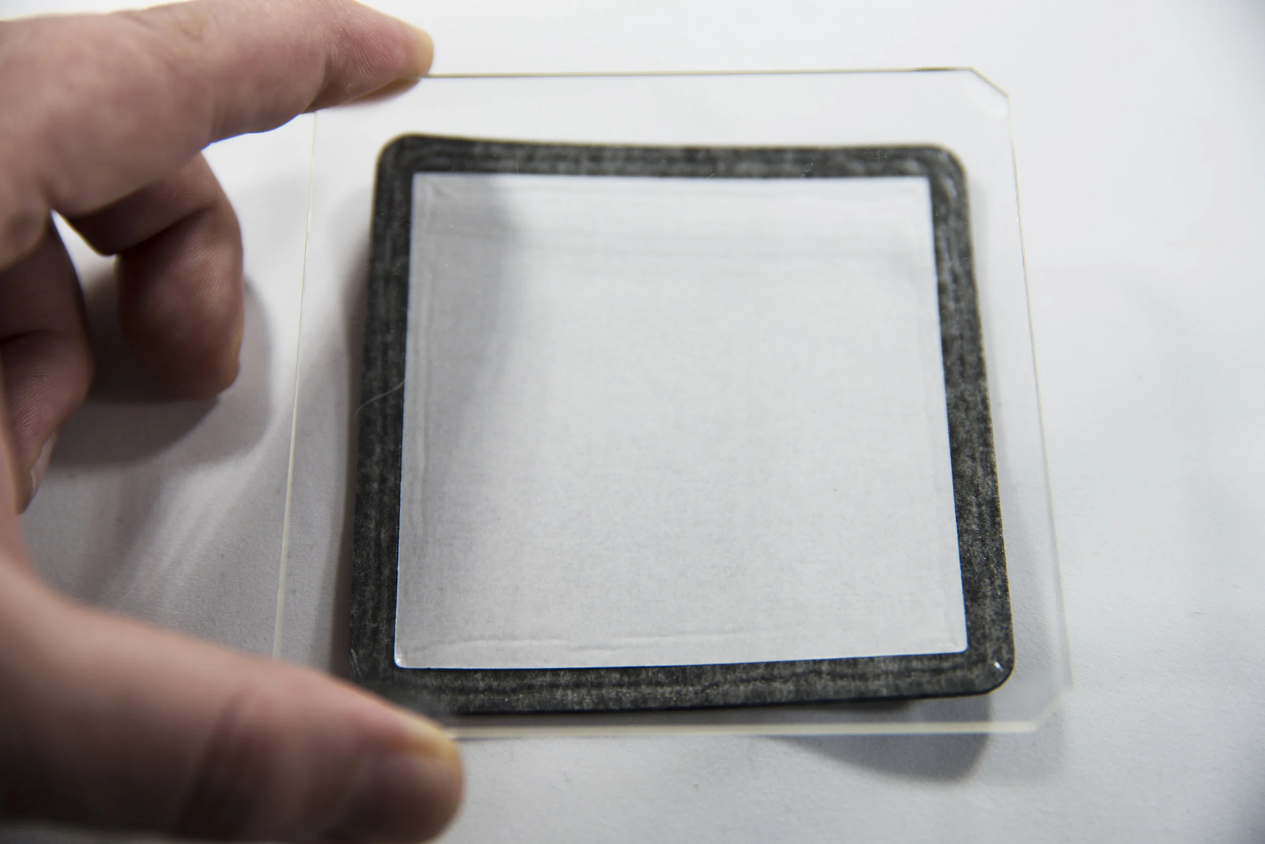 Visually align the filter above the gasket with the etching on the filter facing upwards and using two hands (I needed a hand free to press the shutter in the shot above) place the filter squarely onto the gasket. Instinct will tell you to start at one end and "roll" the filter on to the gasket. The problem with this approach is that if you feel the alignment isn't quite right, you will not easily be able to unstick the gasket and start again. 