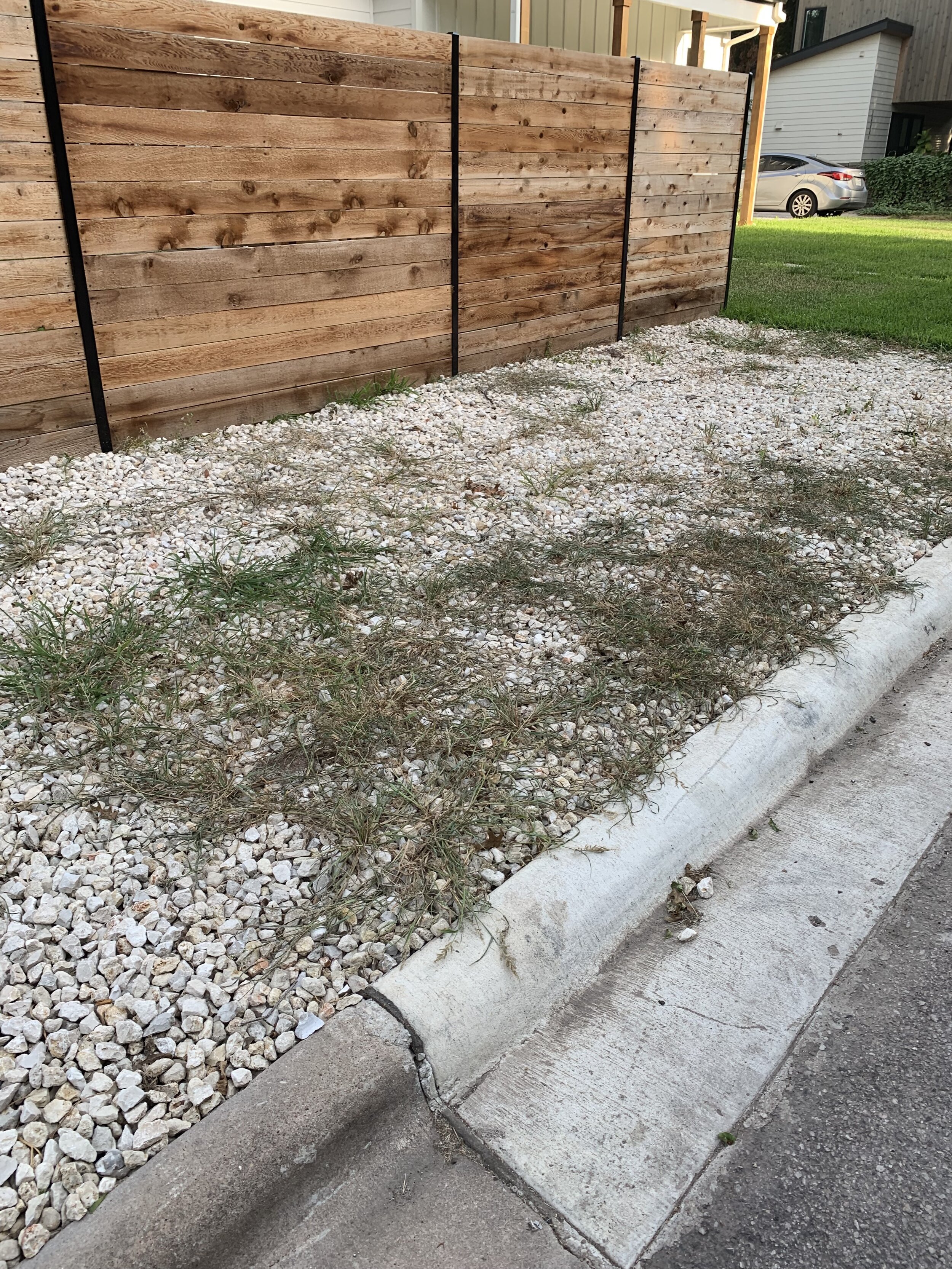  Here, a developer has “rocked over” a side yard. Those unsightly weeds will be a pain to remove.  