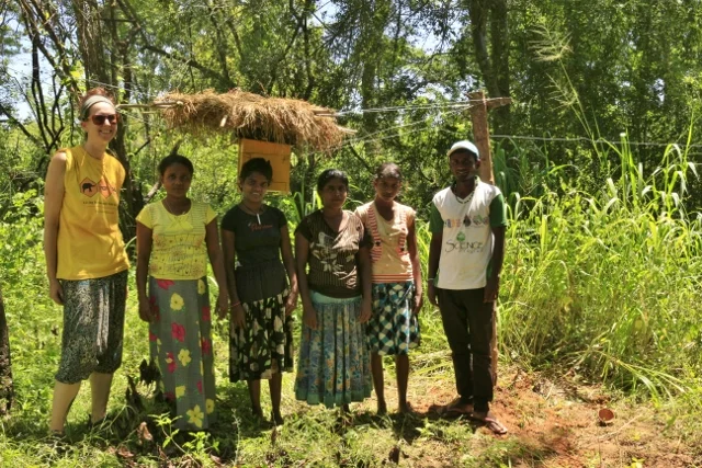 Kylie Butler and Supun Herath (field assistant) with Mrs. Ghanawathi and her family - our newest beehive fence farmers. Mrs. Ghanawathi supports her family alone since the passing of her husband a few years ago, tending the fields and protecting the house. She lives at the edge of Dewagiriya Village, with a forested area along one side of her house and a water tank along the back - making this a prime area for elephant visitation.