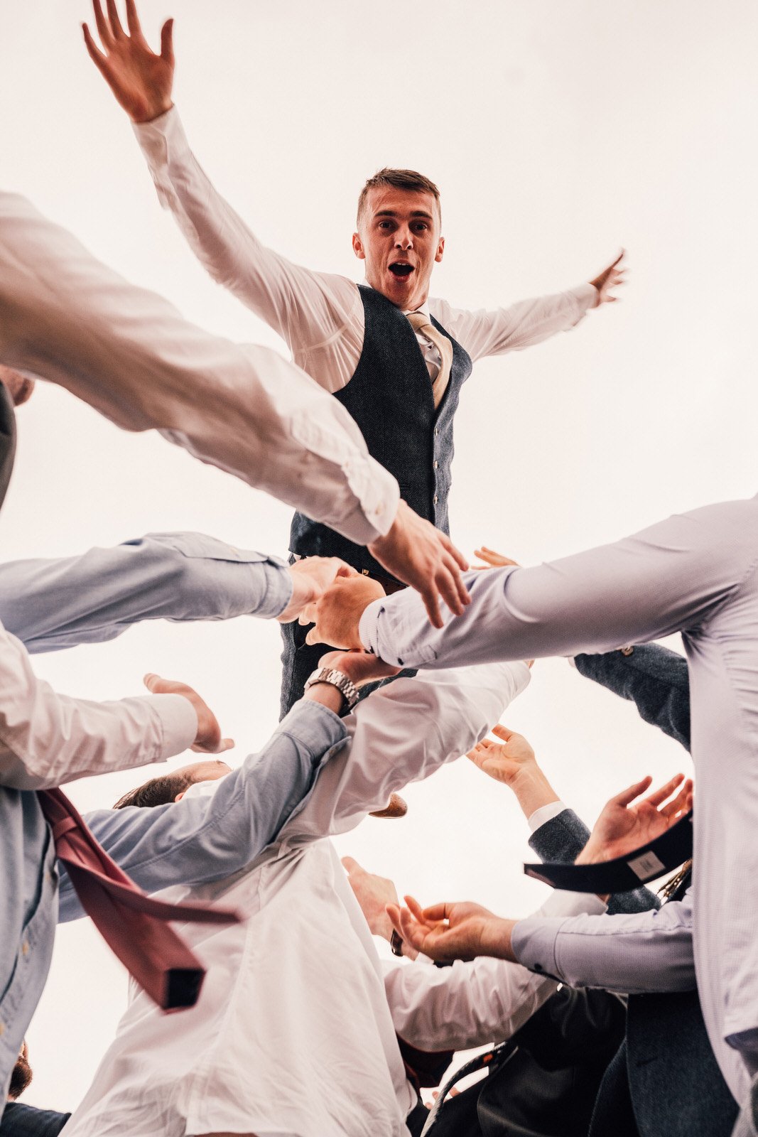 groom being thrown in air