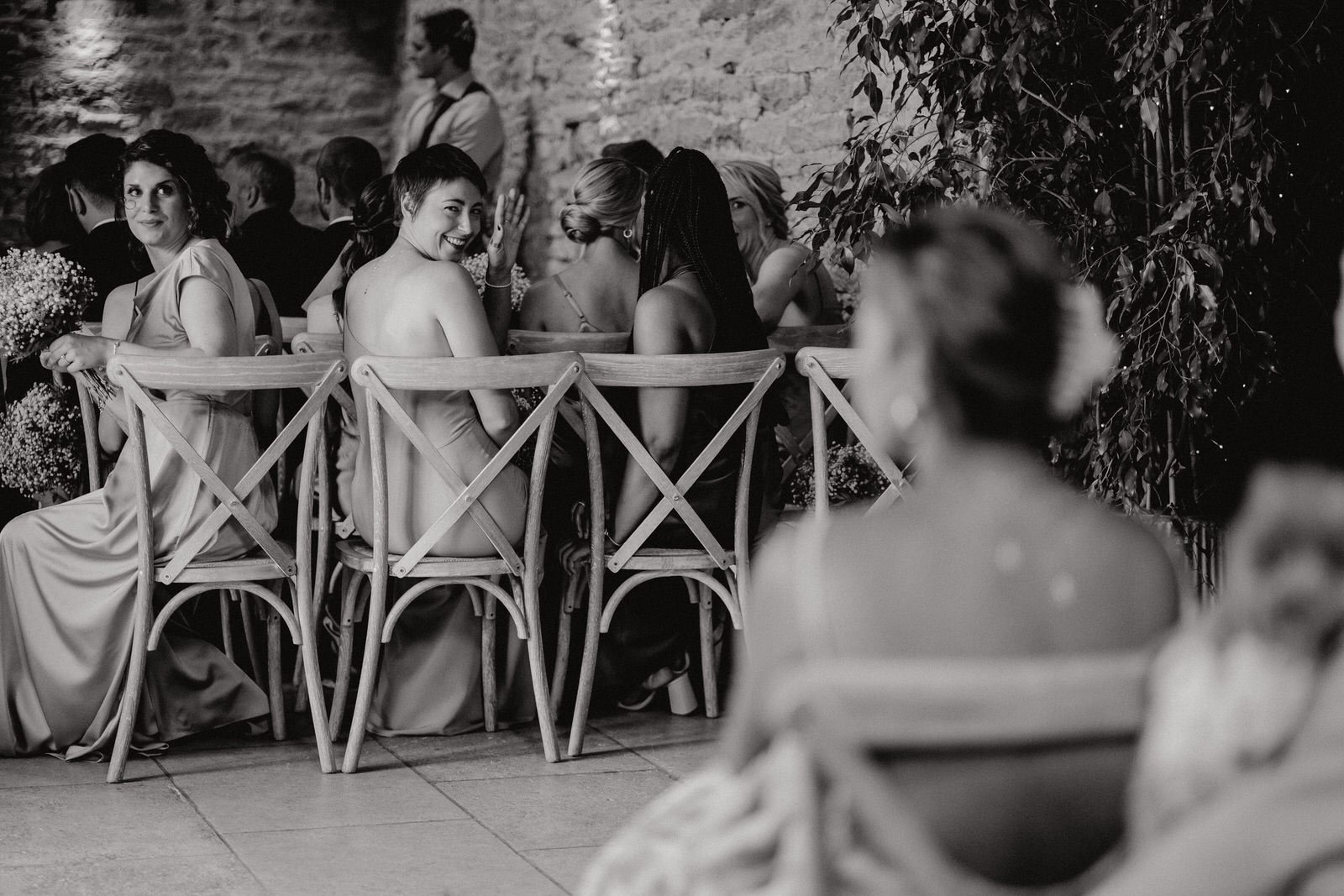 bridesmaids during wedding ceremony stone barn cotswolds