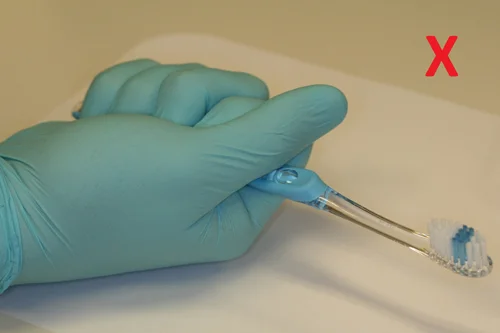 Don't hold your brush forcefully with a fist. This uses larger muscles and can be too abrasive.
