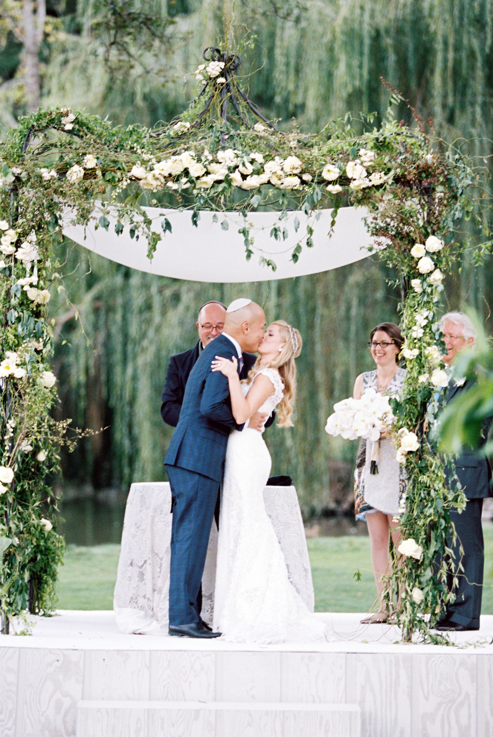 08-the-wedding-chuppah-looked-perfectly-elegant-with-greenery-and-white-flower-decor.jpg