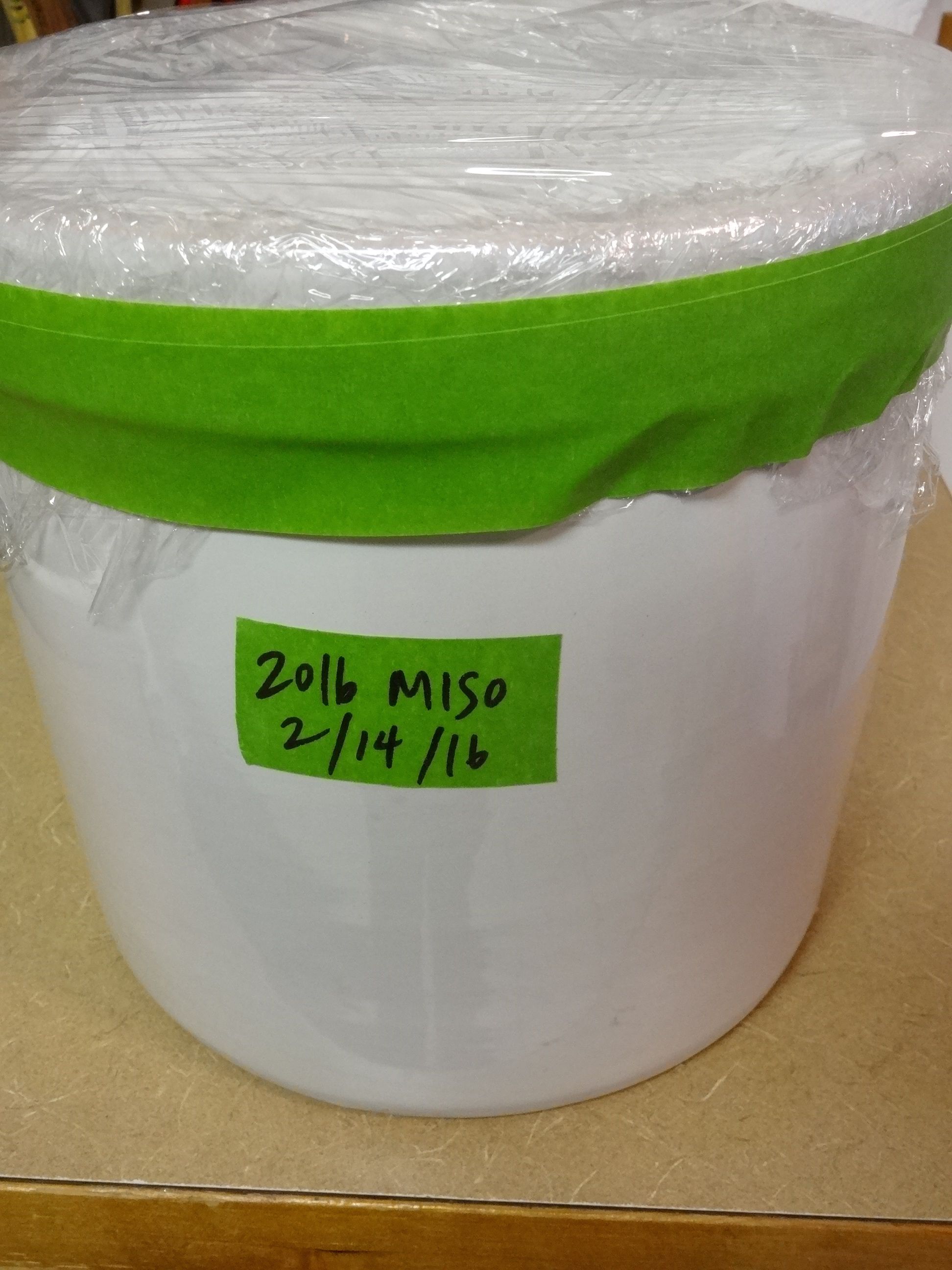 plastic wrap on top, taped, labeled