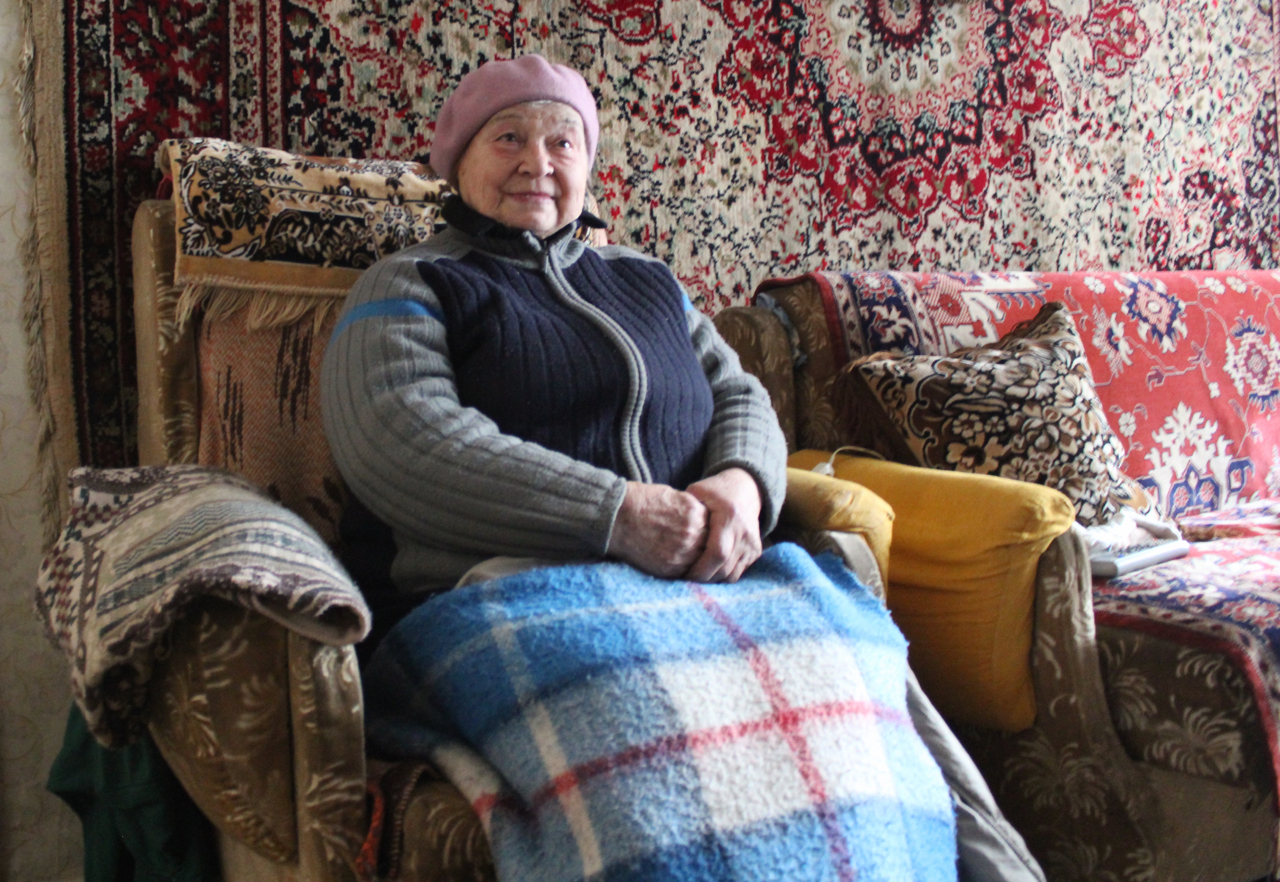 Anna Reshedko, 78, wraps herself in blankets and covers the walls with carpets to stave off the freezing cold 