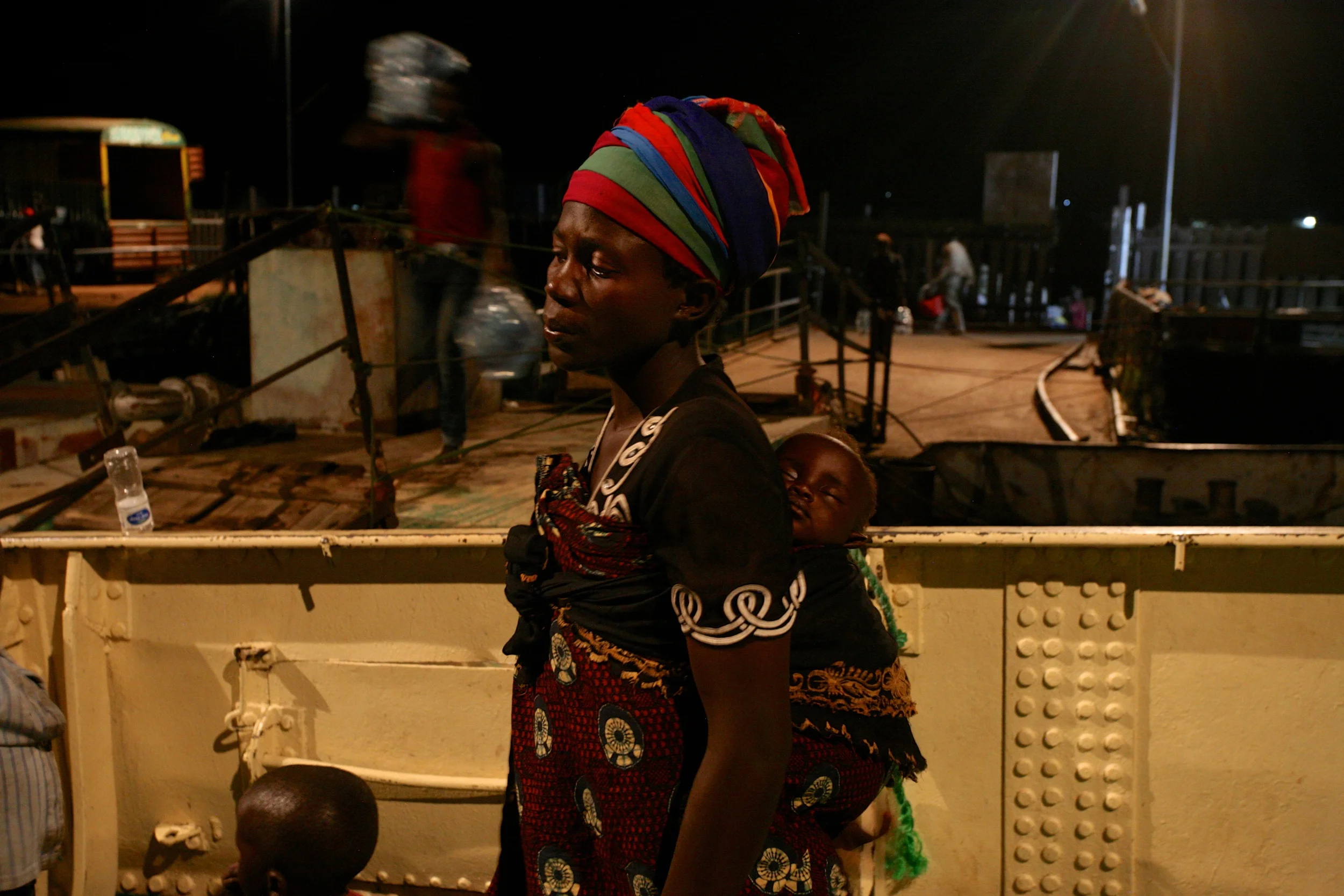 Delphin Nyiyanwi waits aboard the MV Liemba for the body of her 4-year old son to be carried off the boat after he died of suspected cholera.