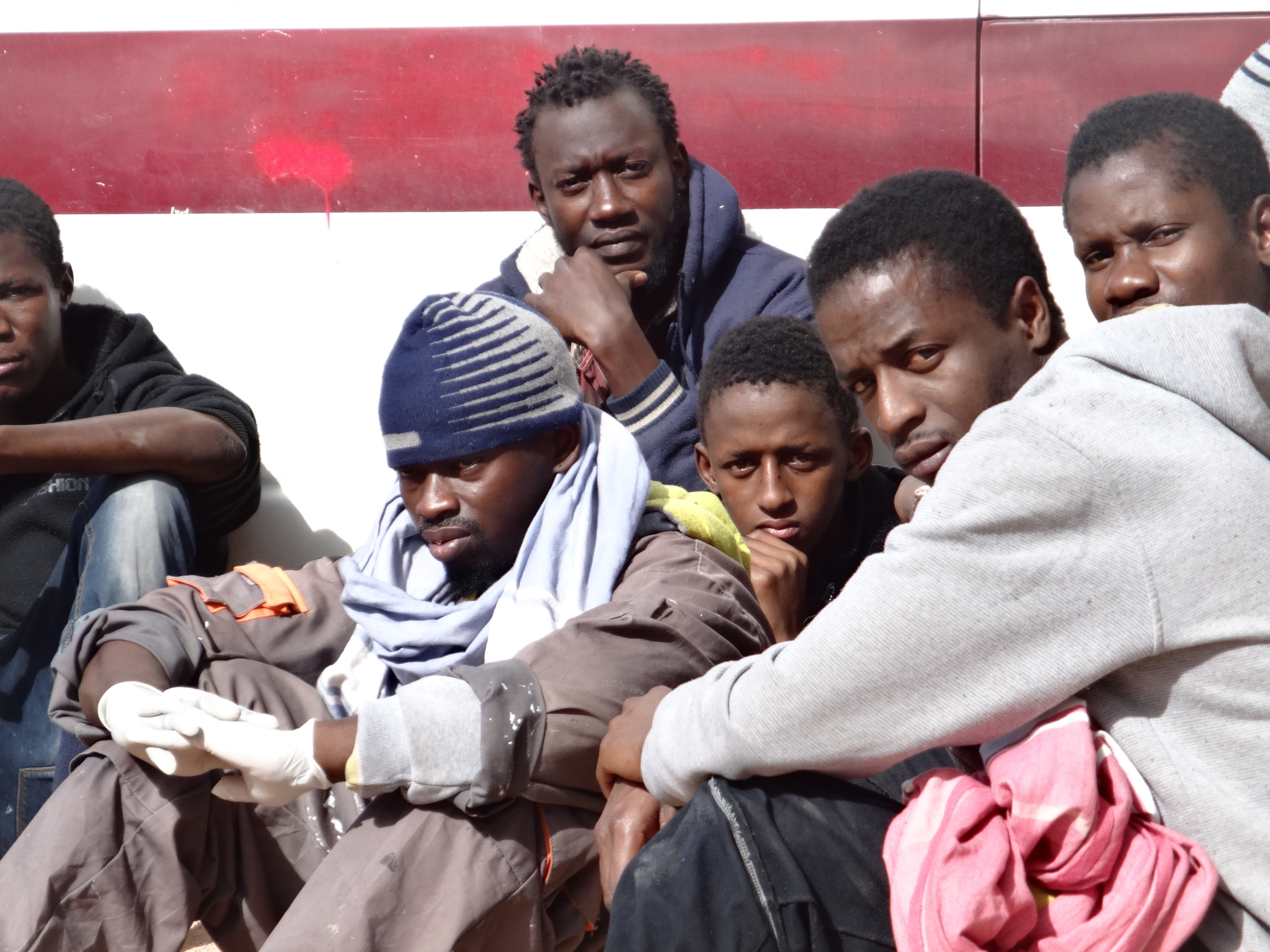 Migrants gather outside the detention centre