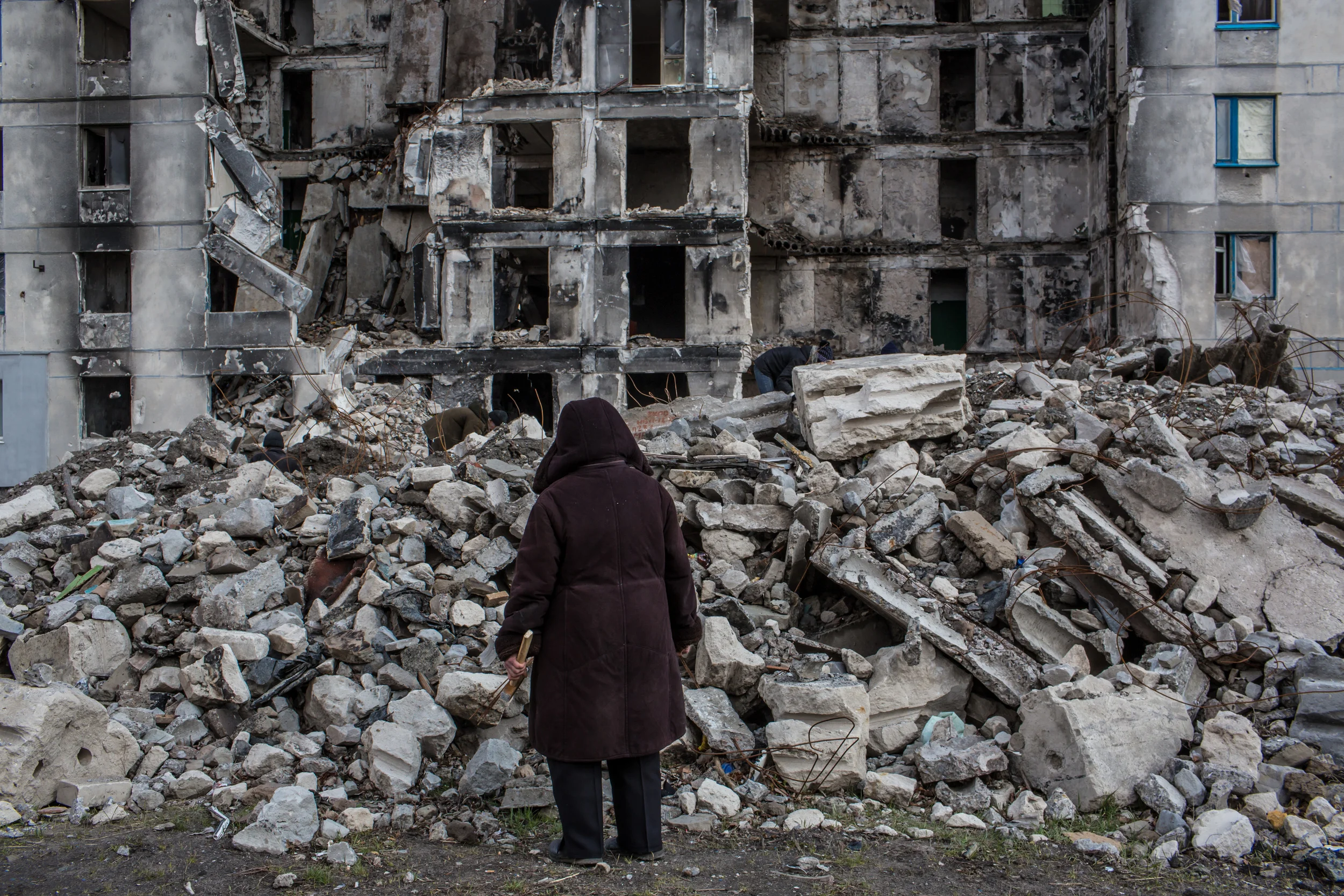 A survey of destruction in Lisichansk, Ukraine. This building was damaged by shelling in July 2014. (Brendan Hoffman for Mercy Corps)