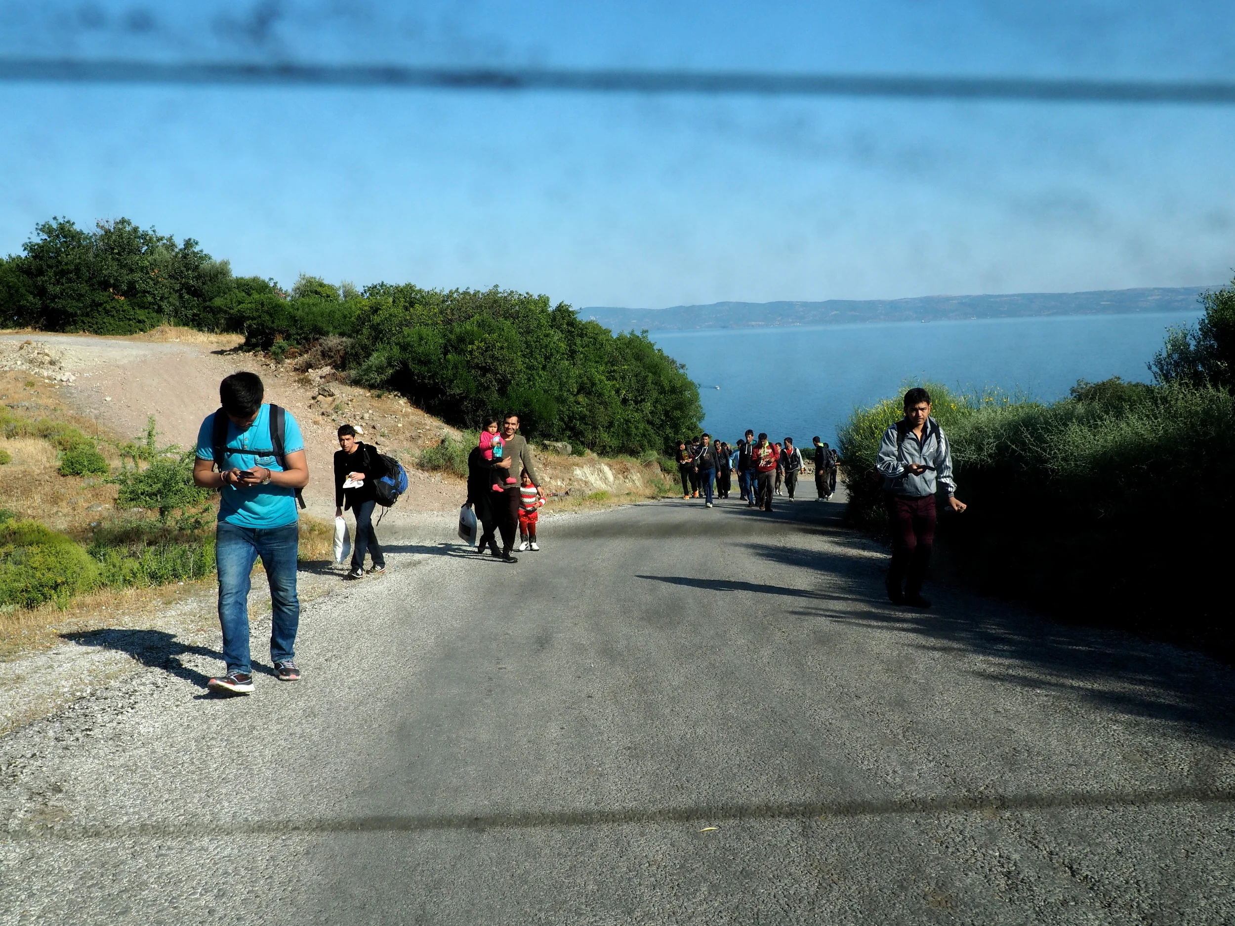 Migrants begin the 60 kilometre trek from Skala Sykaminias to Mytilene. Locals who offer them lifts risk being charged with human smuggling.