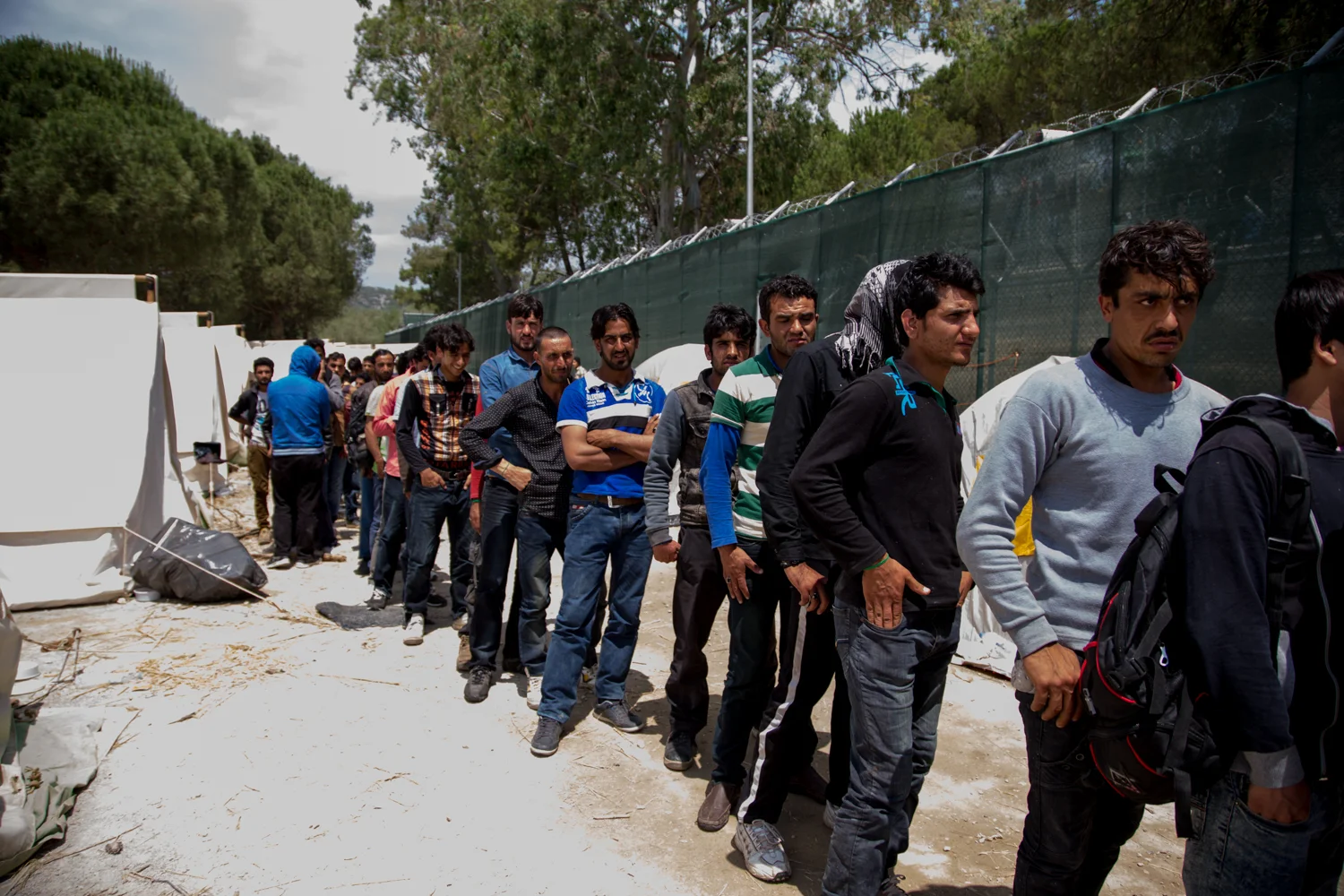 Migrants queue for tea at Moria detention centre