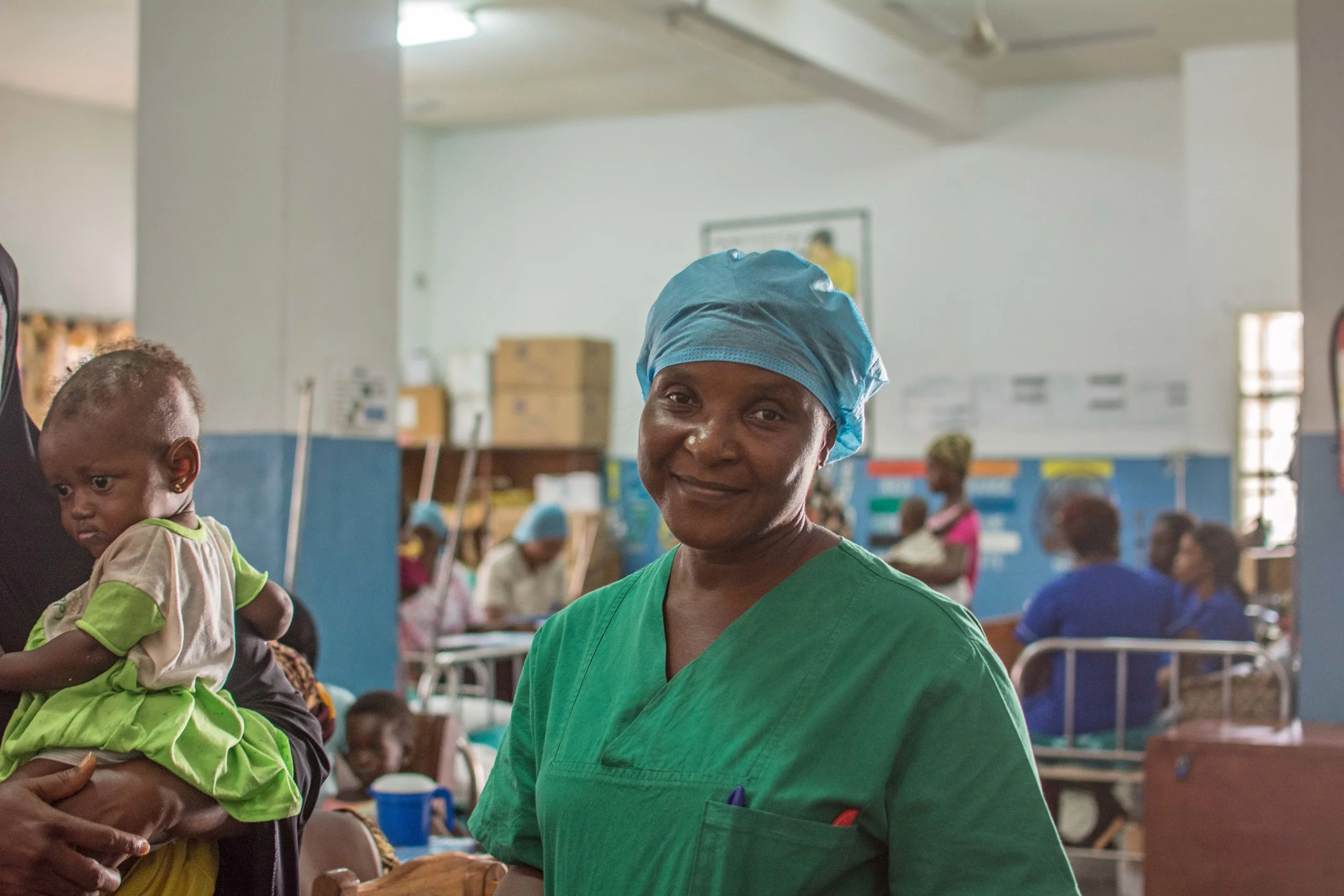 Sister Lucy M.M. Coker treats children for malnutrition at the Cottage Hospital in Freetown. 
