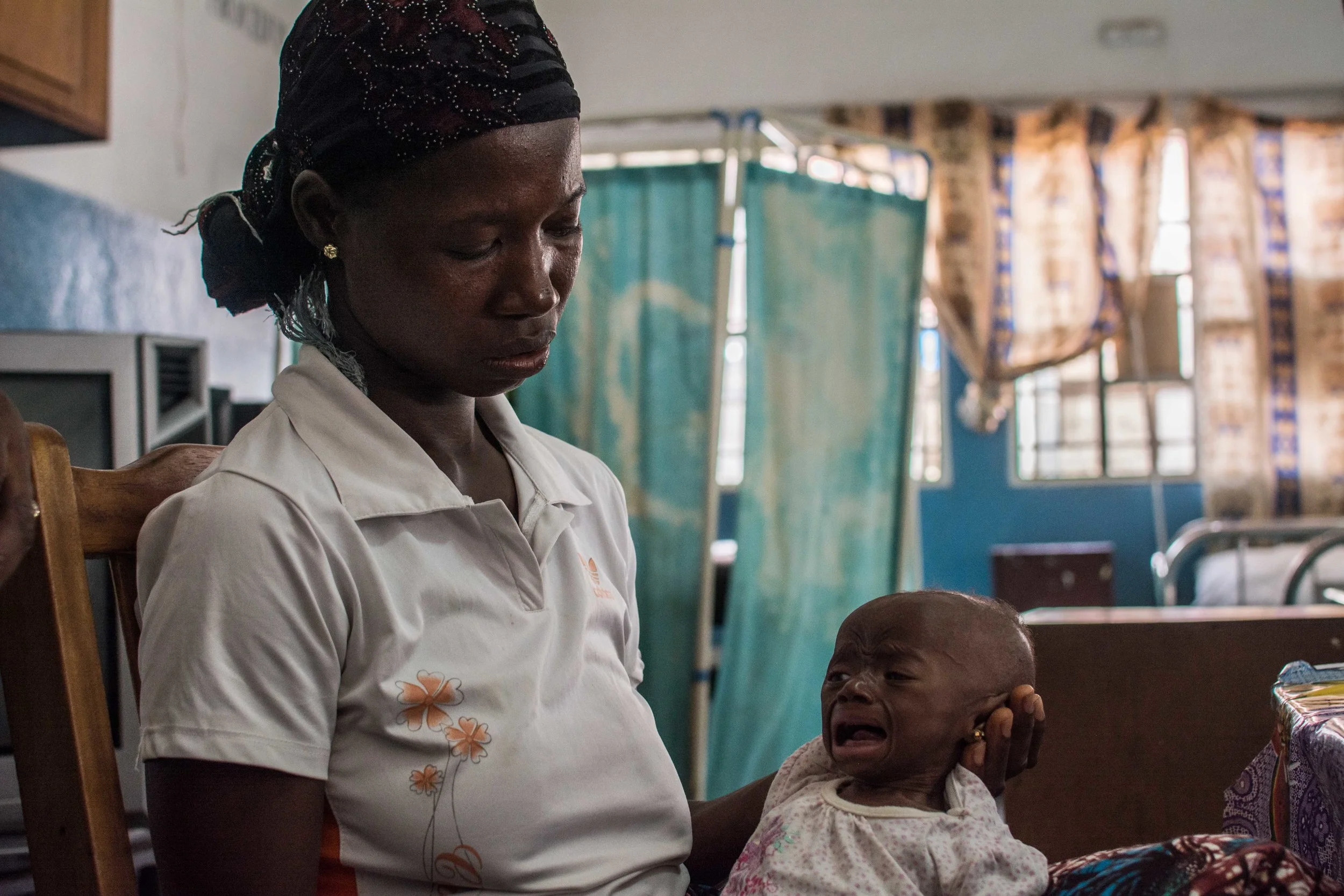 Fatimata Sankoh holds her severely malnourished child at Ola During Children's Hospital in eastern Freetown, where the number of children being treated for malnutrition has also increased since the Ebola outbreak.