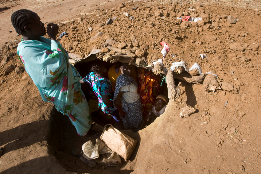 مجموعة من النساء داخل حفرة بعد غارة جوية