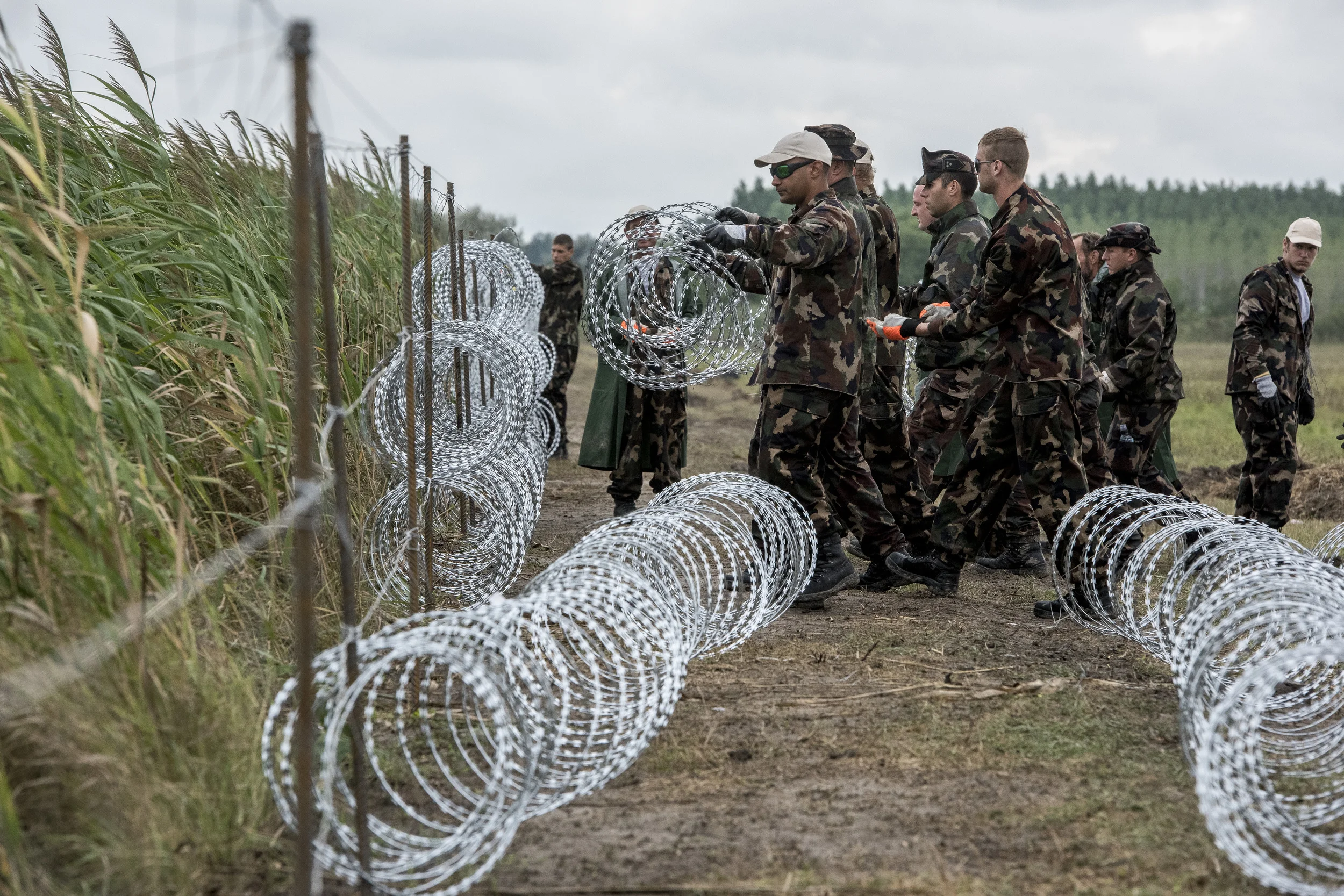 Soldiers are constructing the fence in six-hour shifts, 12 hours a day. The wire is made by convicts in the steel town of Dunaújváros