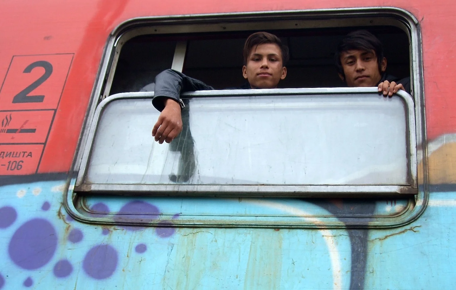 Afghan refugees, Ali and Mohamed, on board the train about to depart for the Serbian border