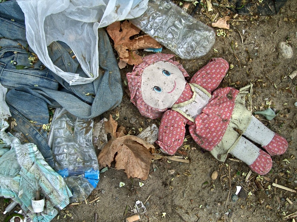Among the scrubby grape vines outside the camp, all the detritus of human life can be found (Mark Perry/IRIN)