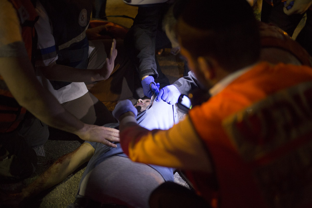 Magen David Adom volunteers treat a stabbing victim. The "magen david" is the six-pointed Star of David, and "adom" means red. The MDA has released a video advising citizens how to help stabbing victims