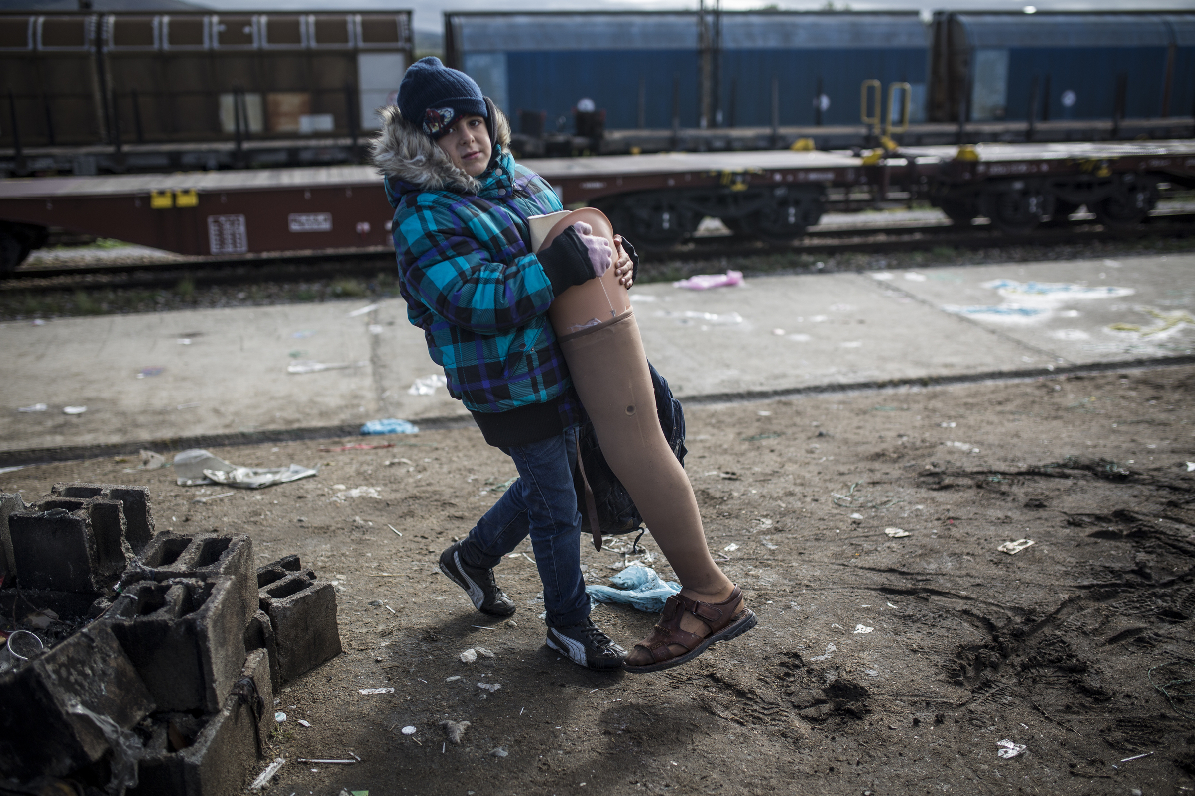 Bashar's grandson, aged seven, and also called Bashar, carries his grandfather's prosthetic leg