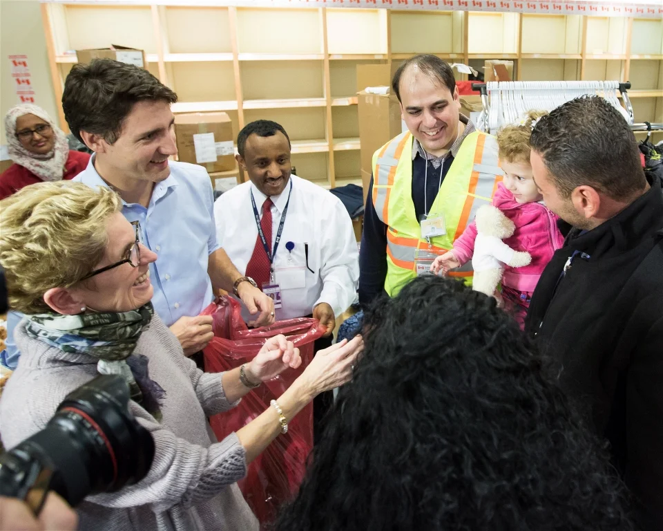 Canadian Prime Minister Justin Trudeau and Ontario Premier Kathleen Wynne welcome Syrian refugees Kevork Jamkossian and his daughter Madeleine who have been privately sponsored to come to Canada (PMO of Canada)