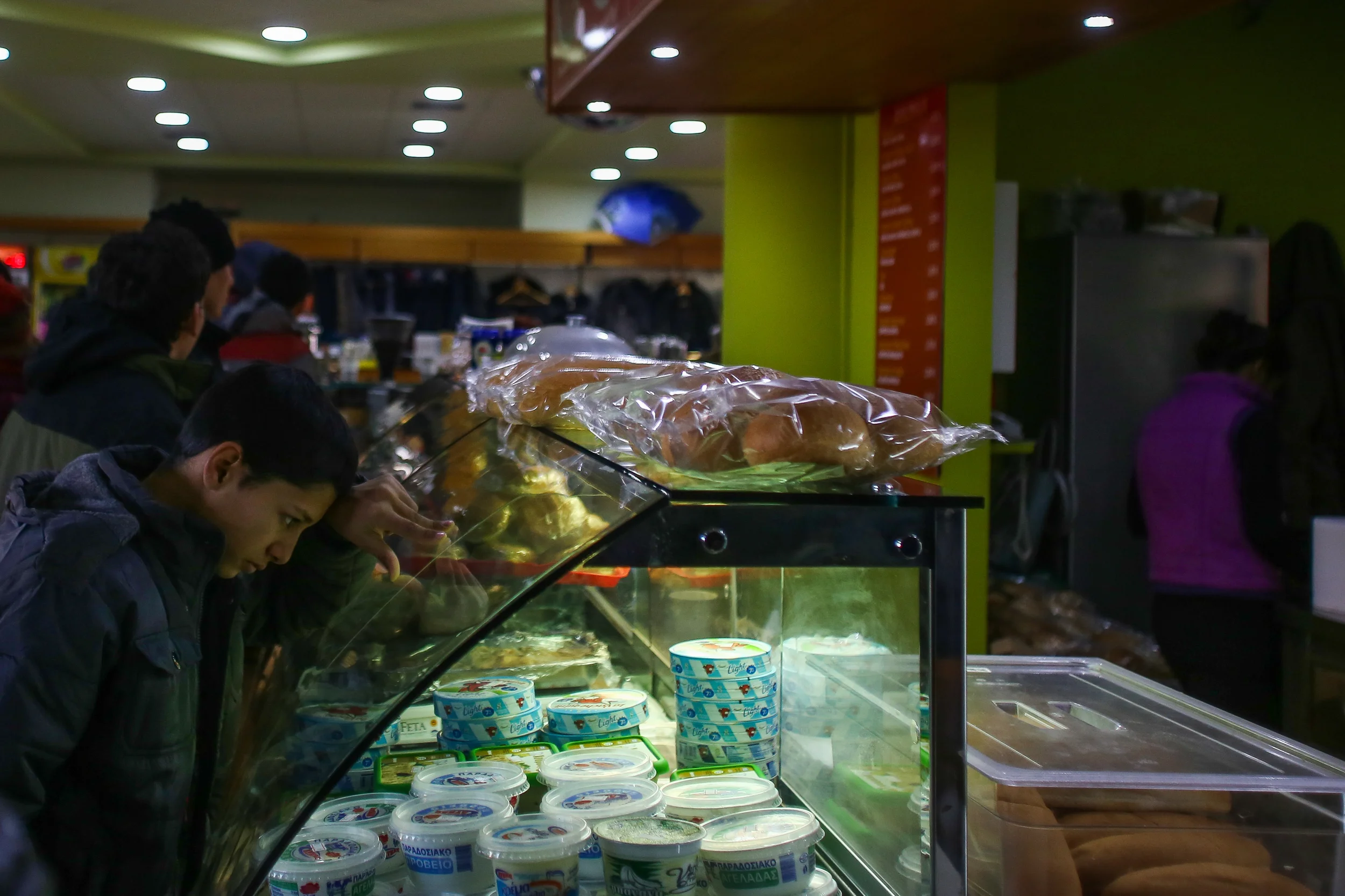 A Syrian boy in the small cafe run by the petrol station where Greek police are forcing buses carrying refugees and migrants to stop for days at a time before proceeding to the Macedonian border. Many wait so long there that they are forced to buy food. Free food along with clothes and medical assistance is available at a transit camp just 20 kilometers away. 