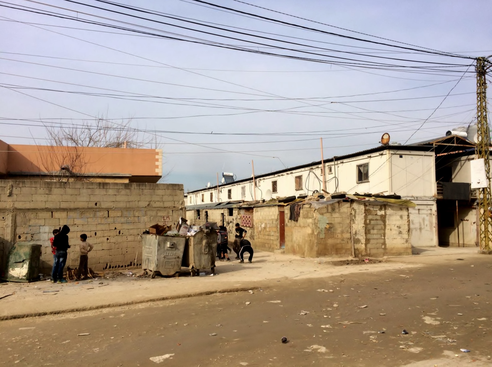  Kids play near a bin in Nahr al-Bared 