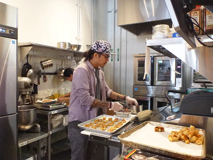 Geo preps appetizers for the celebratory brunch. Sweet meets savory with waffle and salmon lox and cream cheese bites. Photo by Jill Wasberg.