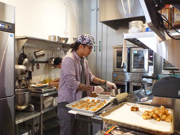 Geo preps appetizers for the celebratory brunch. Sweet meets savory with waffle and salmon lox and cream cheese bites. Photo by Jill Wasberg.