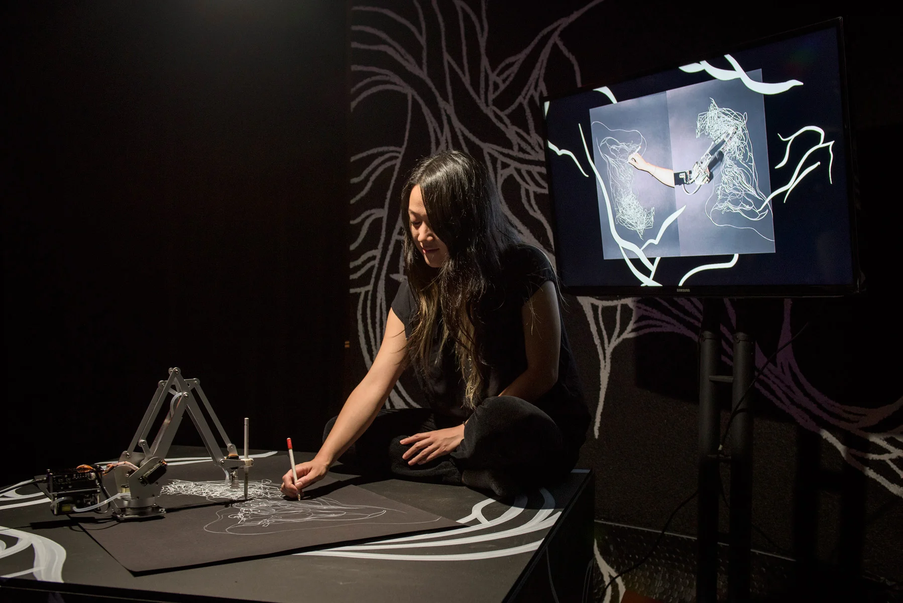Sougwen performing with D.O.U.G.  Photo via Red Bull Studios.
